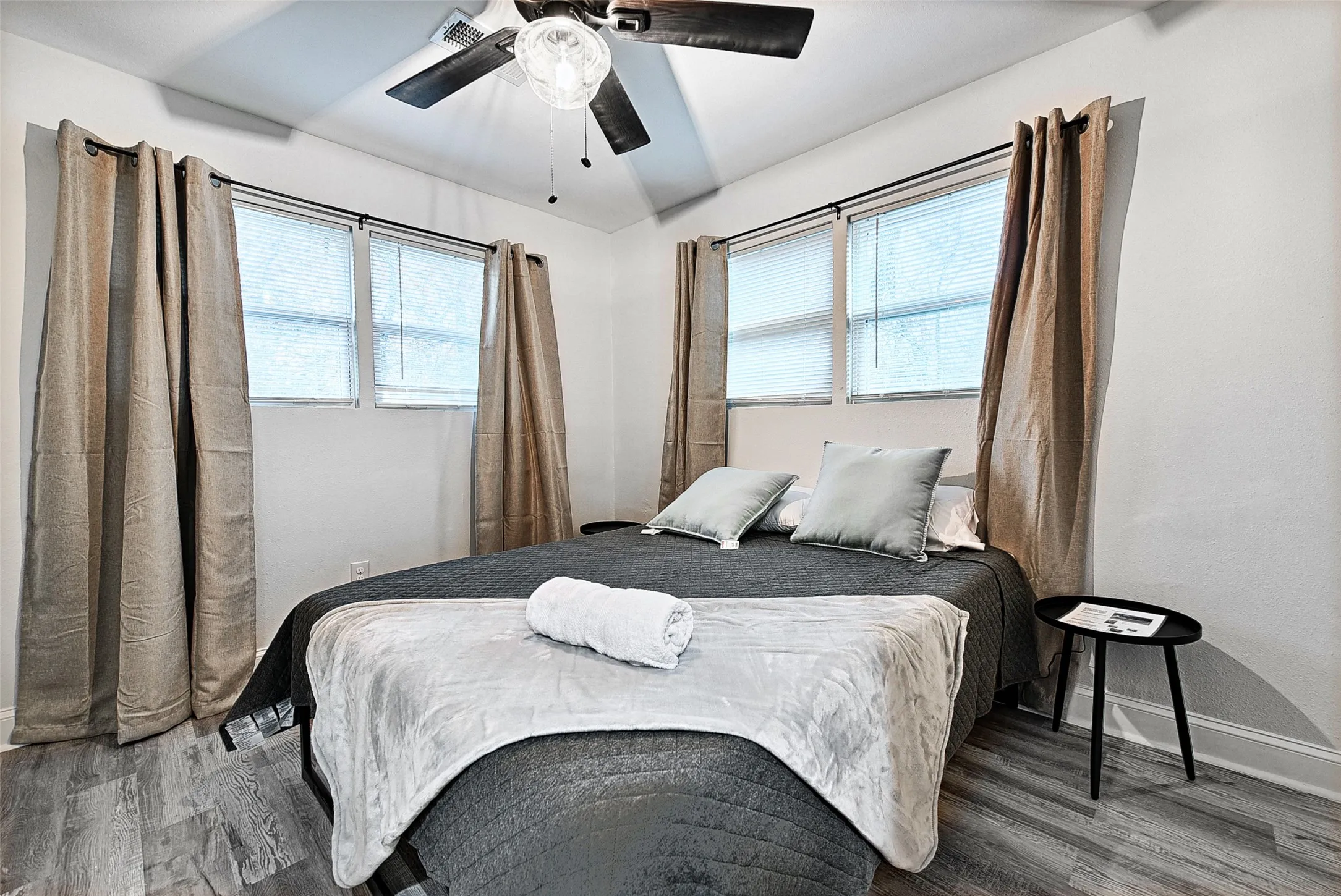 Bedroom with lofted ceiling, hardwood / wood-style flooring, and ceiling fan