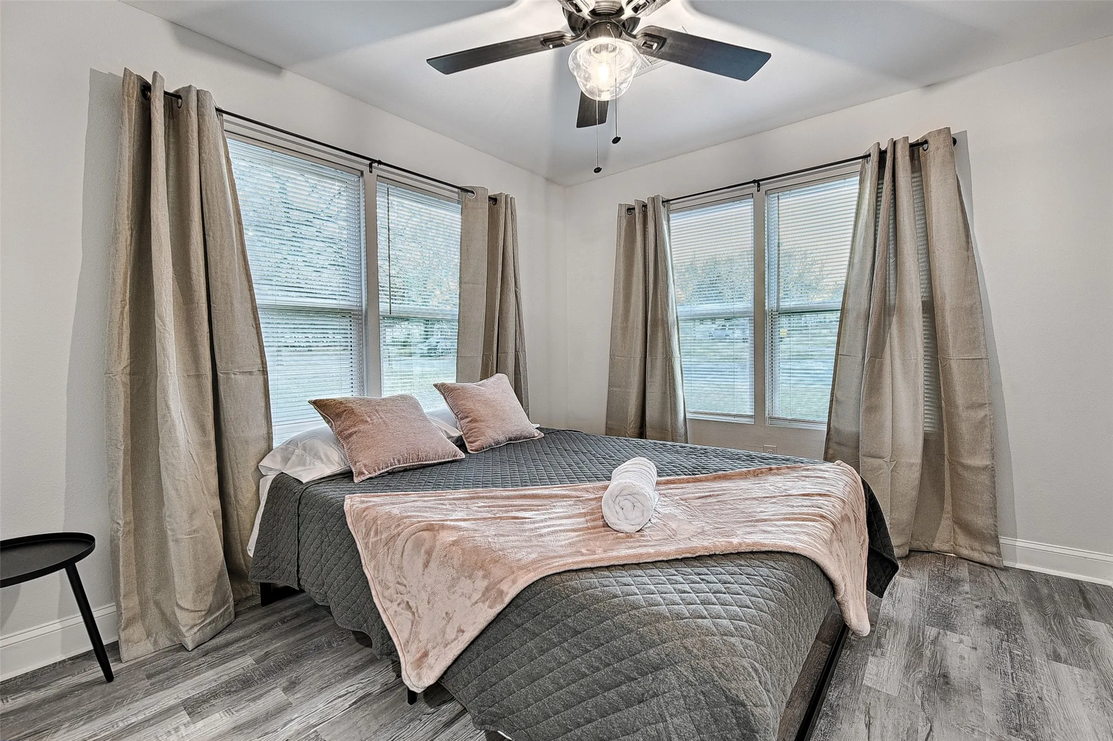 Bedroom with hardwood / wood-style floors and ceiling fan