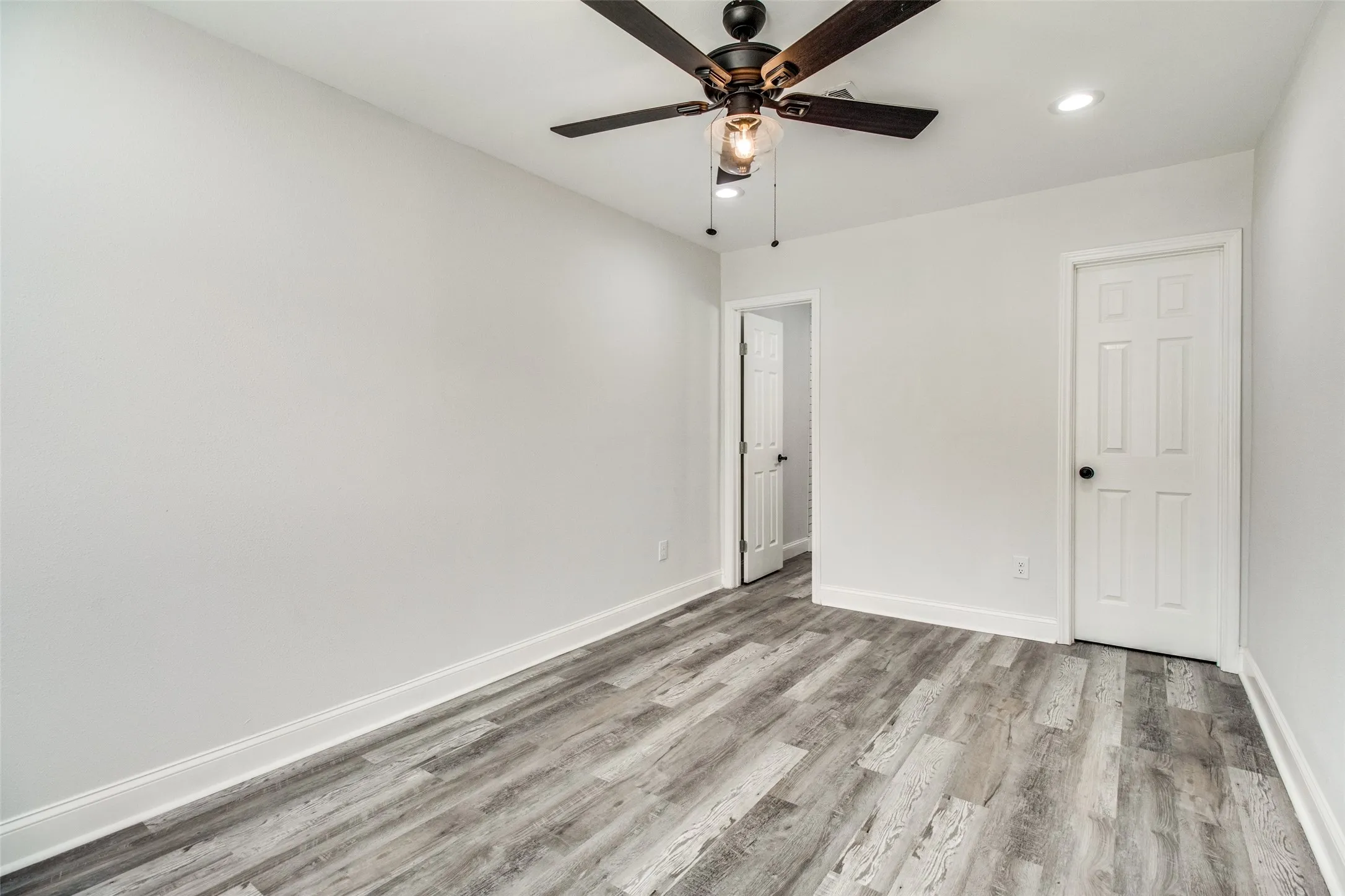 Spare room with light hardwood / wood-style floors and ceiling fan