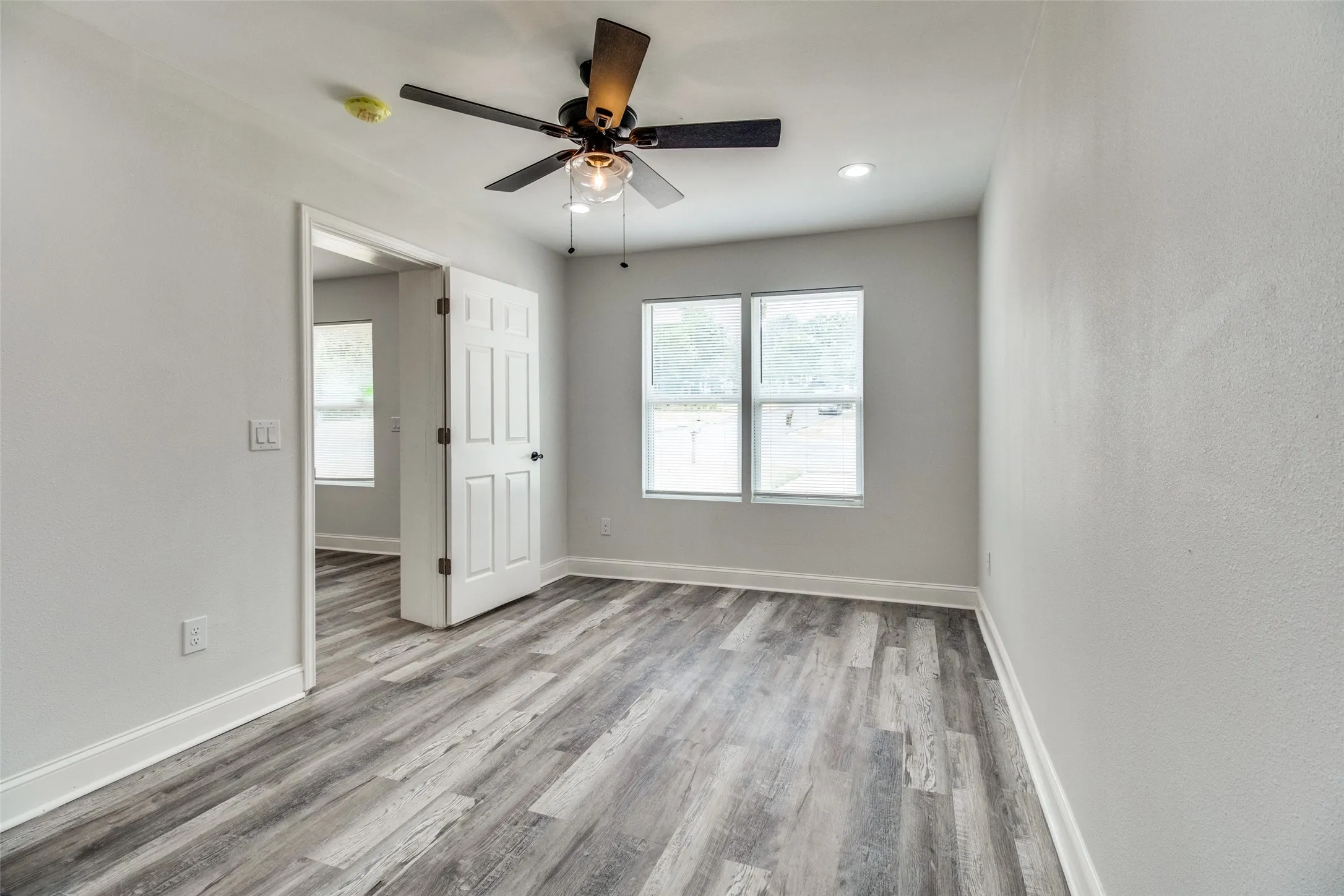 Spare room featuring ceiling fan and light hardwood / wood-style floors