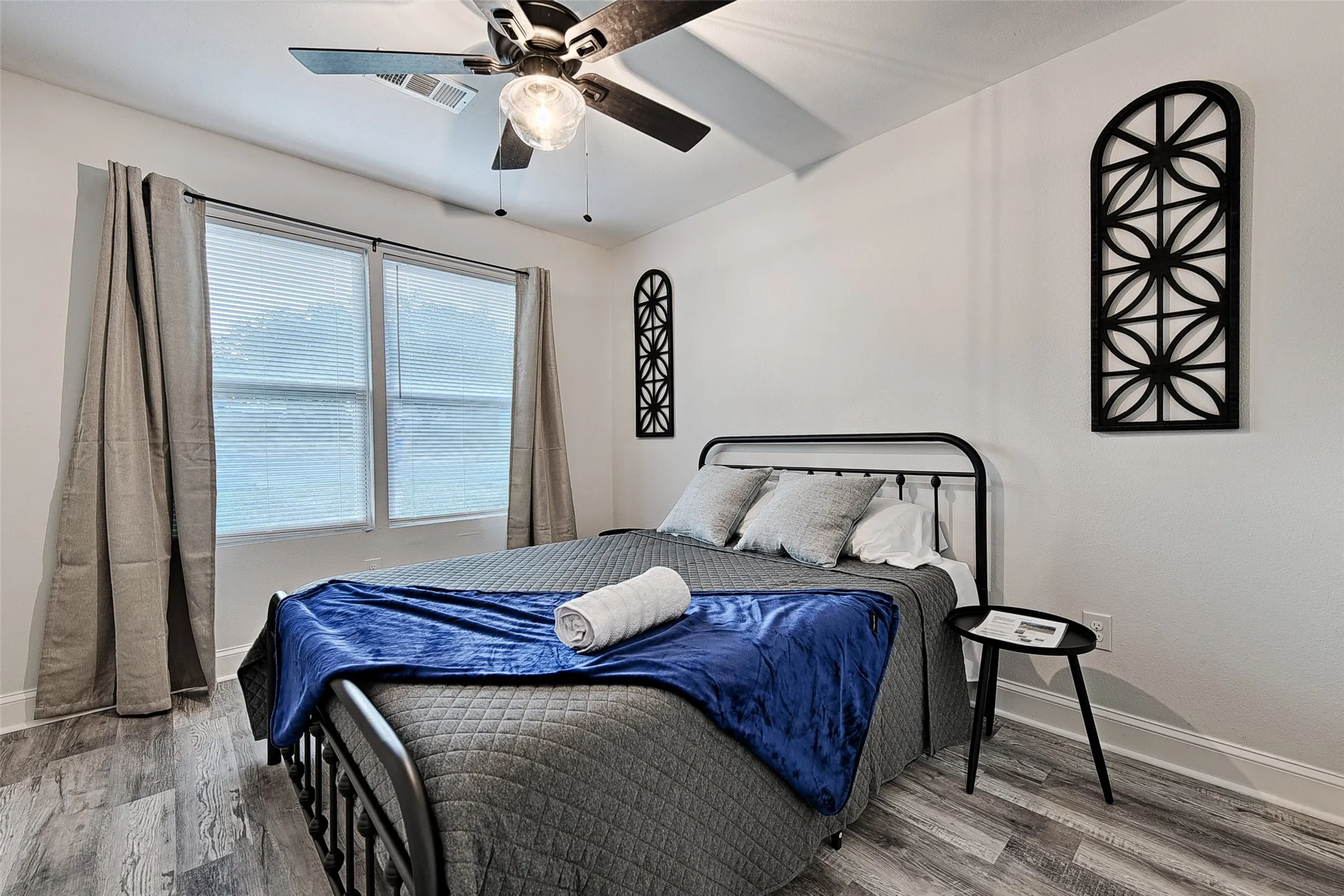 Bedroom featuring hardwood / wood-style flooring and ceiling fan