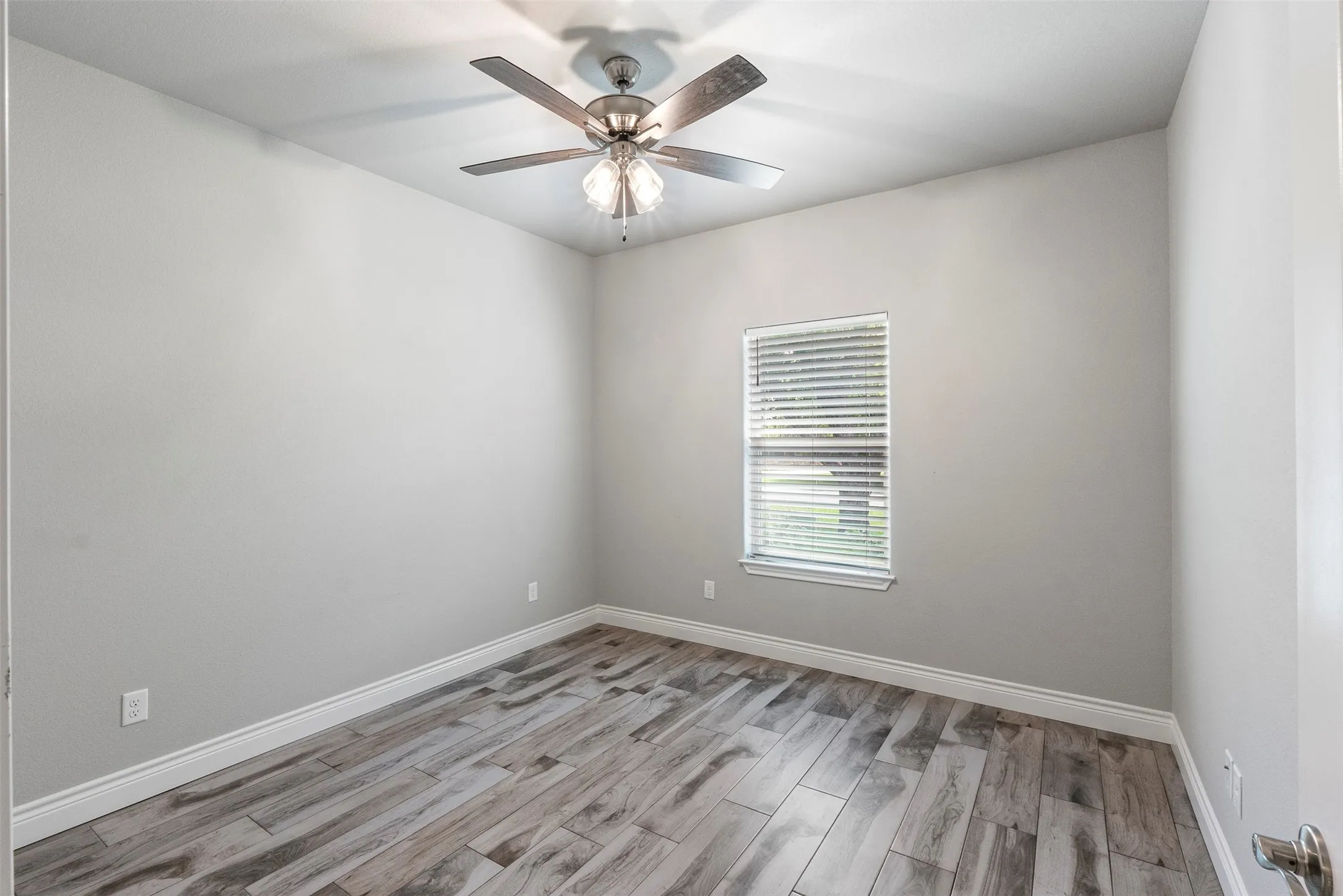 No carpet anywhere in the home—durable wood-look tile flooring runs throughout all living areas and bedrooms.
