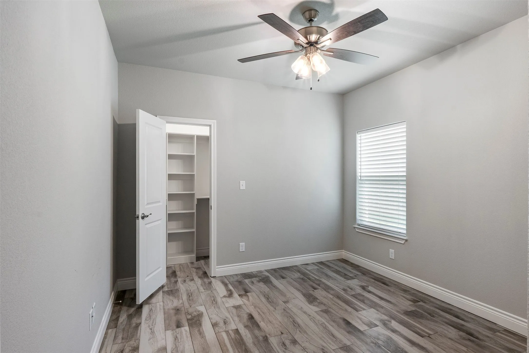 Spacious secondary bedroom with closet storage and flexibility for guests, family or home office.