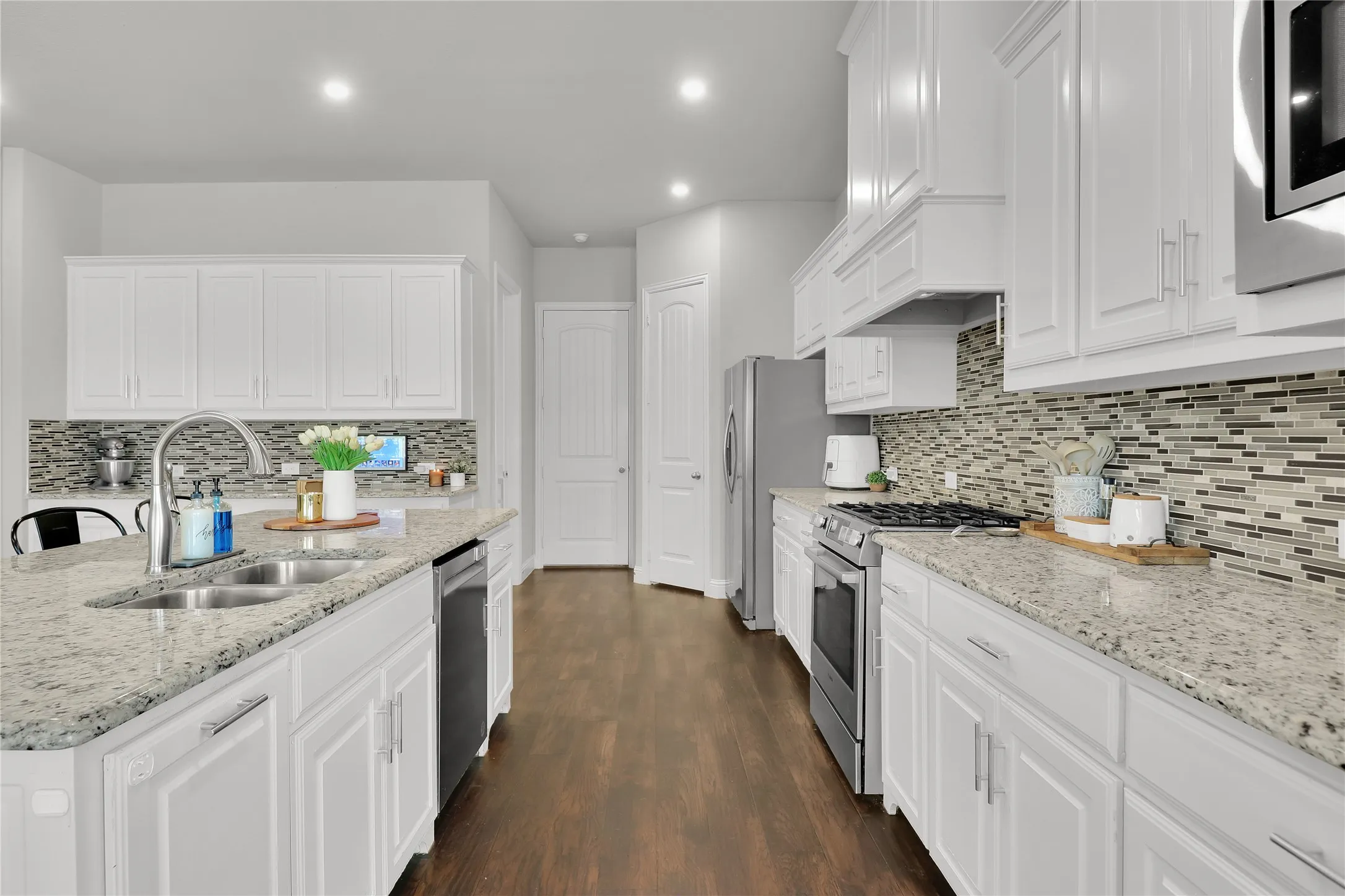 Middle door leads to garage. Door to right is the pantry and the door to the left is the laundry room.