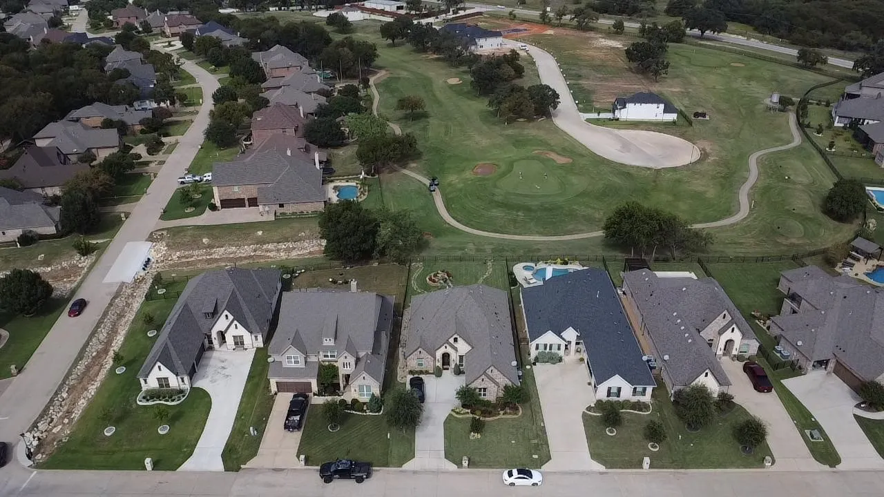 The second house from left is the subject property.