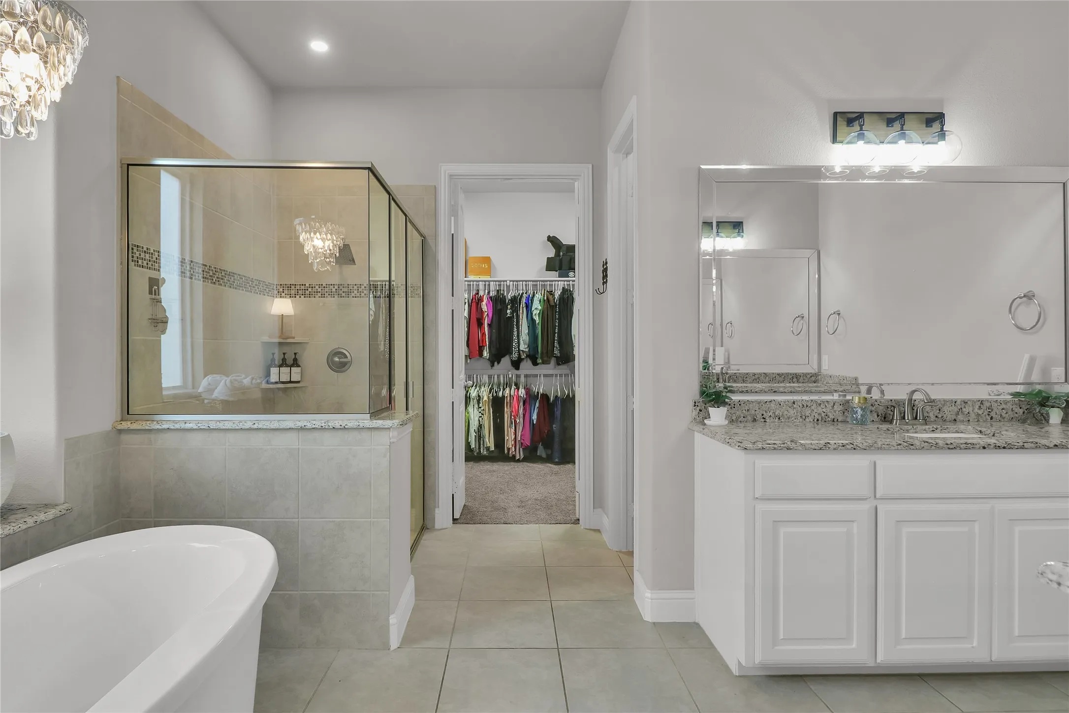 En suite bath with soaking tub, separate shower, dual vanities an walk in closet.