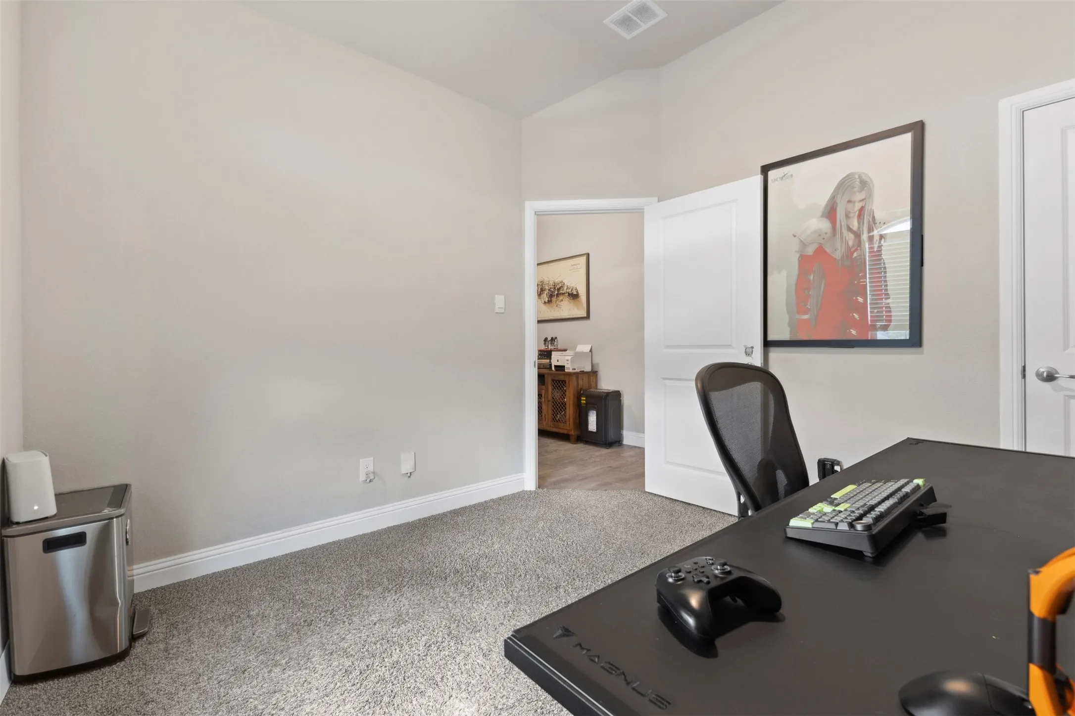 Room featuring neutral wall tones, grey carpeting, a white baseboard, and a white interior door