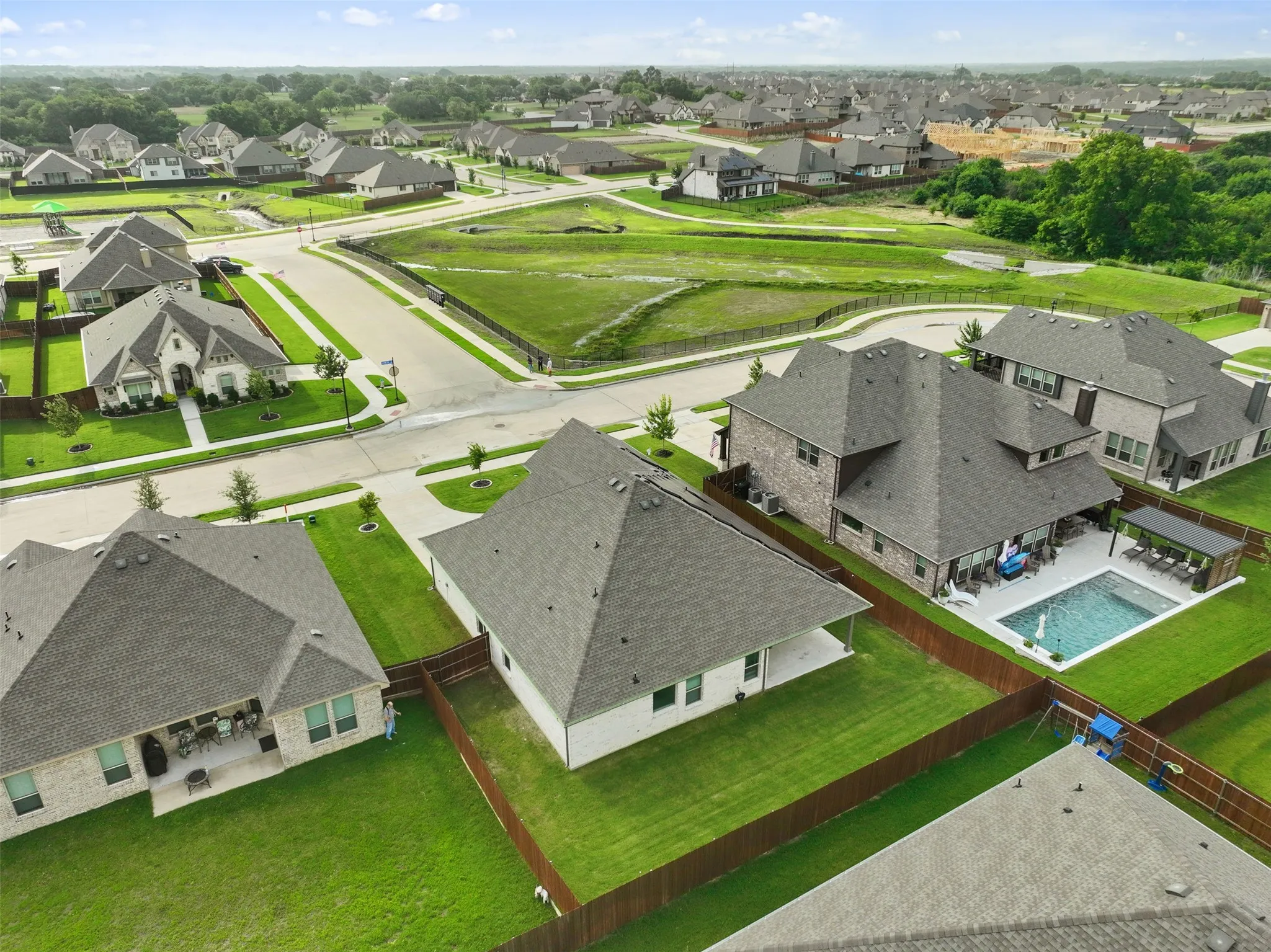 Residential community featuring a variety of single-family homes with pitched roofs and manicured lawns