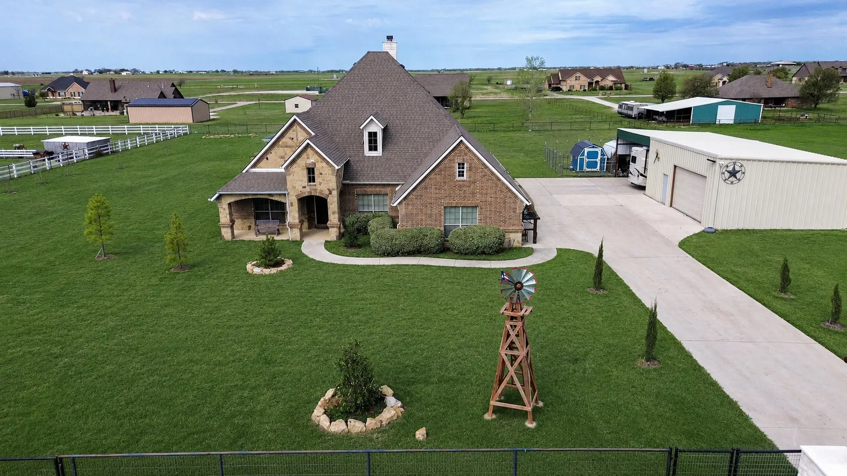 Brick and stone exterior home with a dormer window and covered front porch