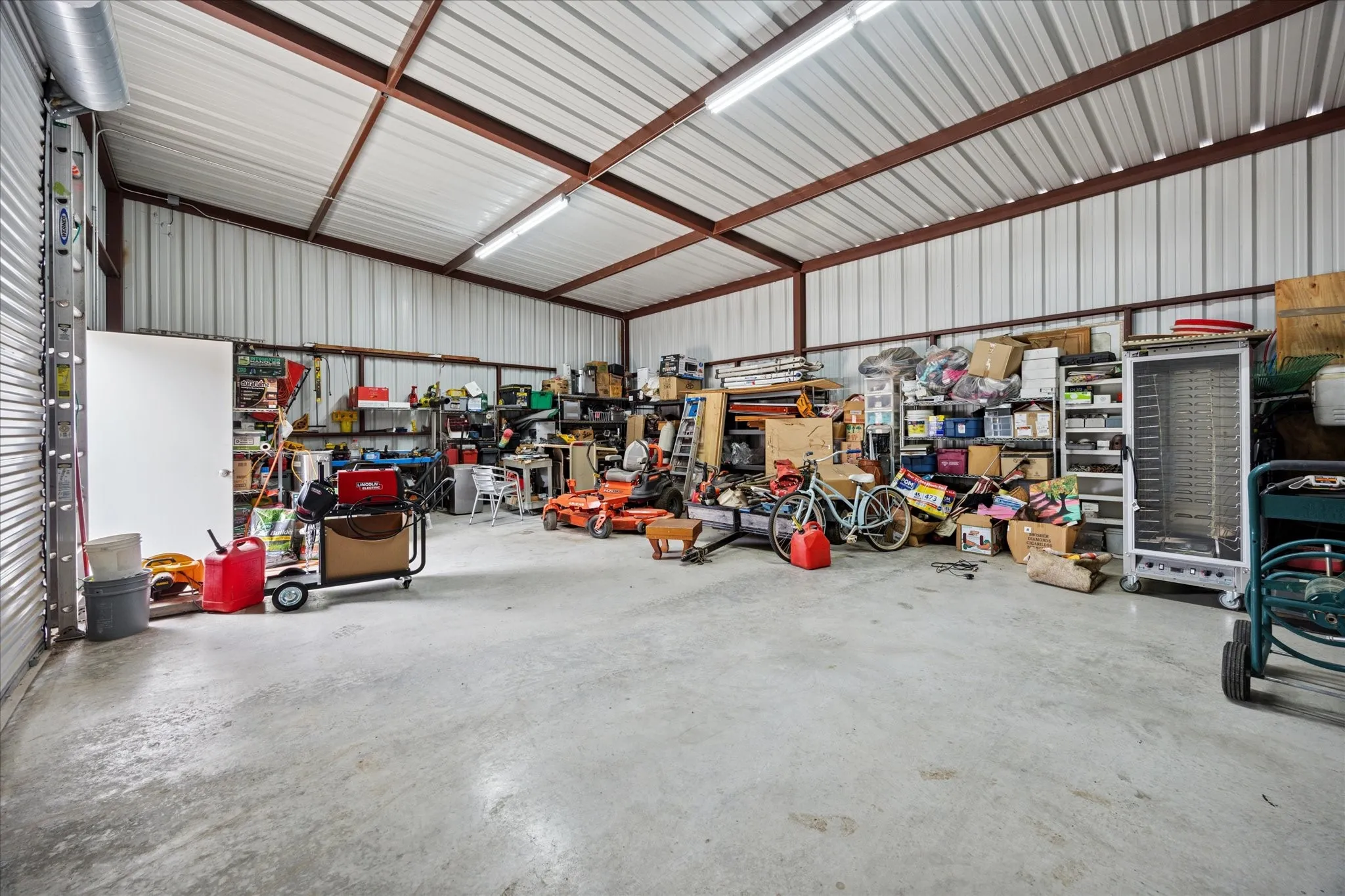 Spacious metal-frame building featuring a corrugated metal roof, durable concrete flooring, and ample storage capacity