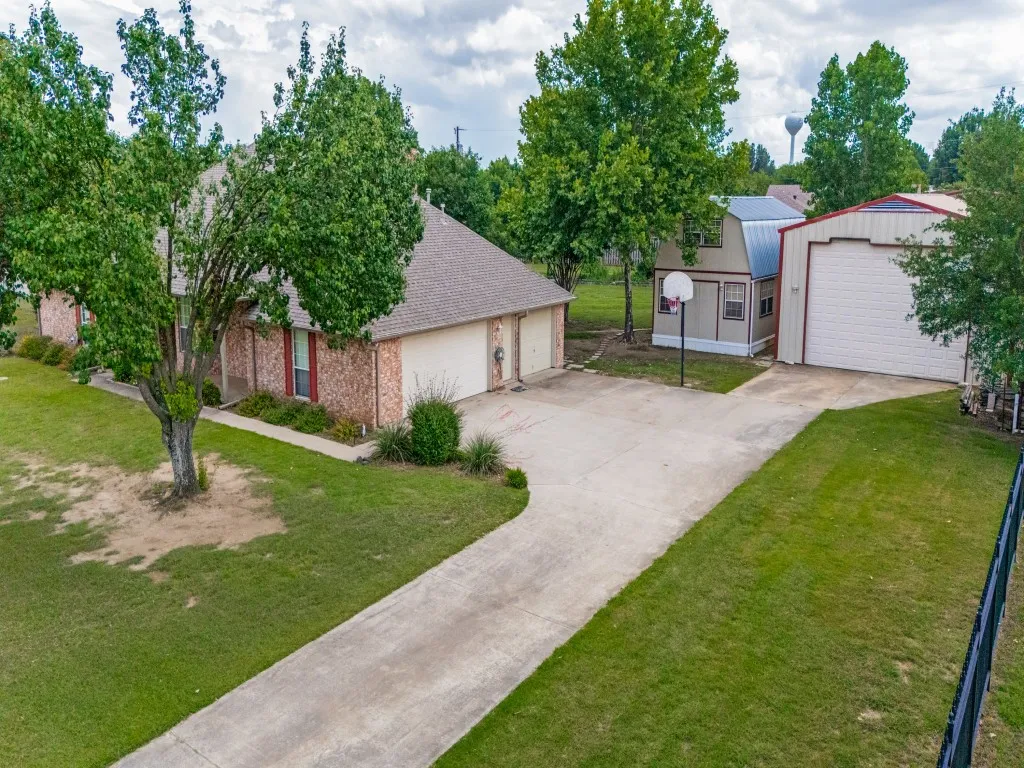 Driveway View of RV Bay and Two-Story Storage Shed