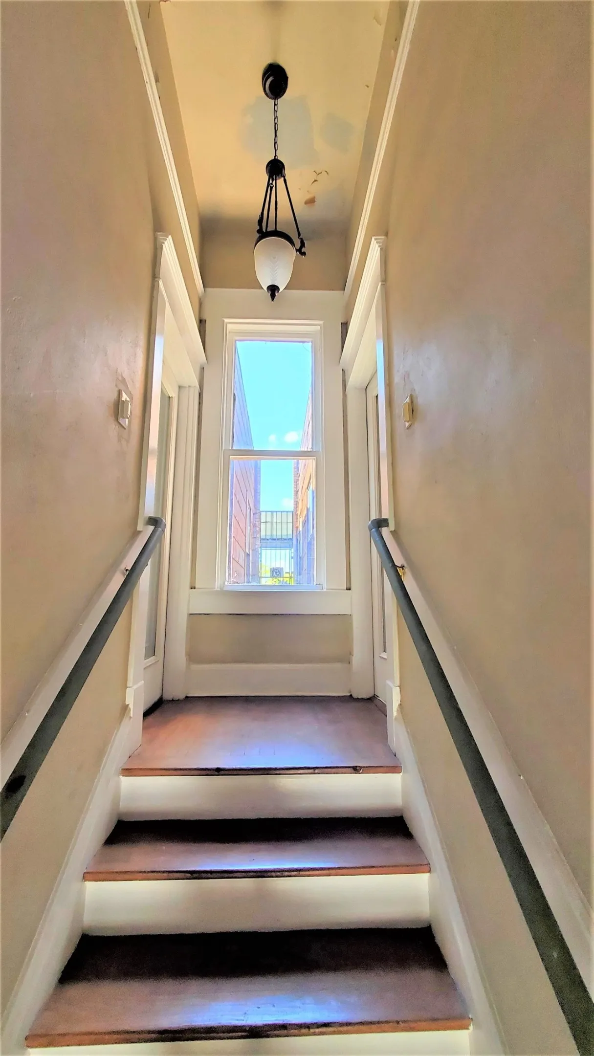Stairway up to front door in living room