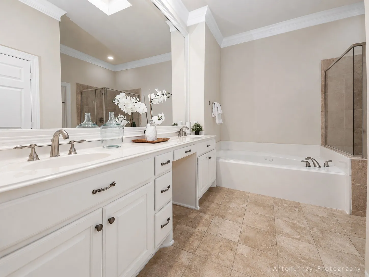 Primary bathroom features a double vanity, shower, and large walk-in closet
