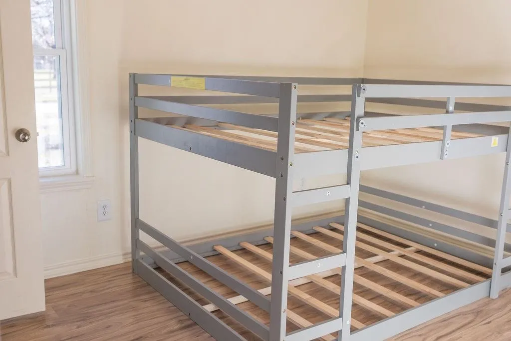 Spacious room featuring wood-finish flooring, a window providing natural light, and neutral wall tones
