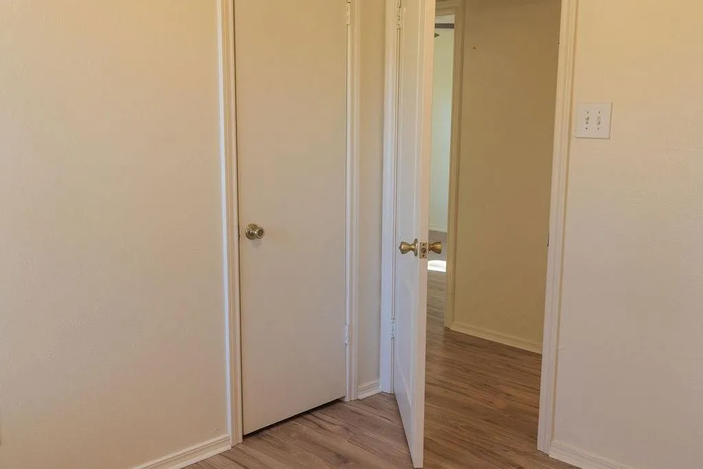 Interior space featuring wood-finish flooring, light-colored walls, and white trim