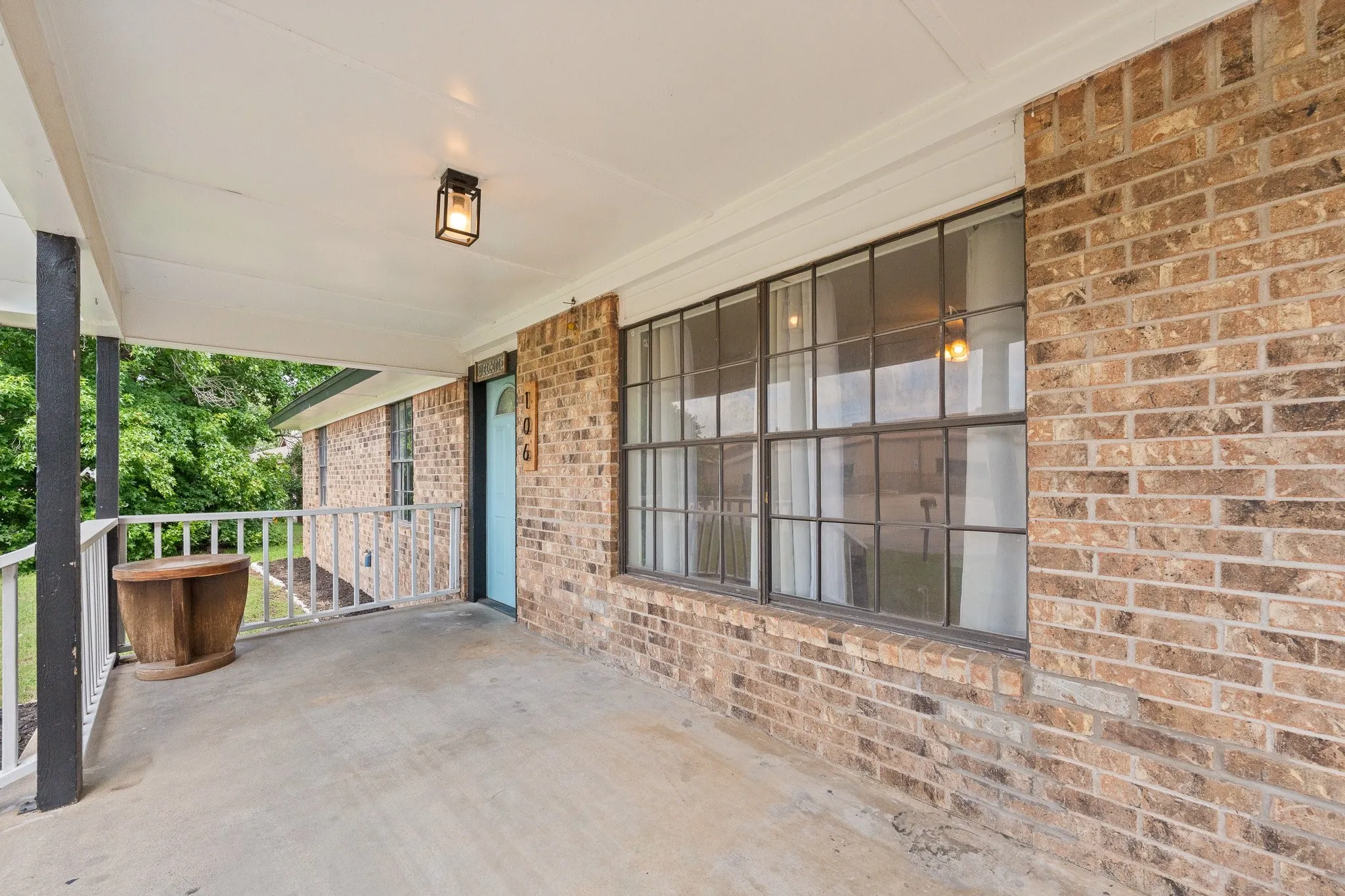 Brick exterior with a covered concrete porch
