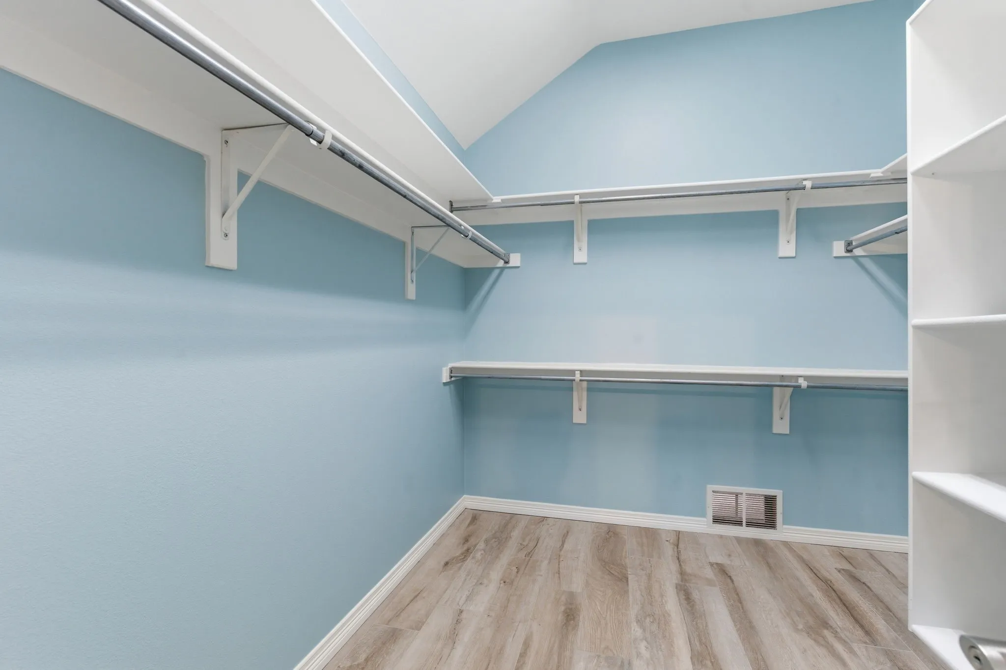Custom closet in primary bath with water resistant flooring.