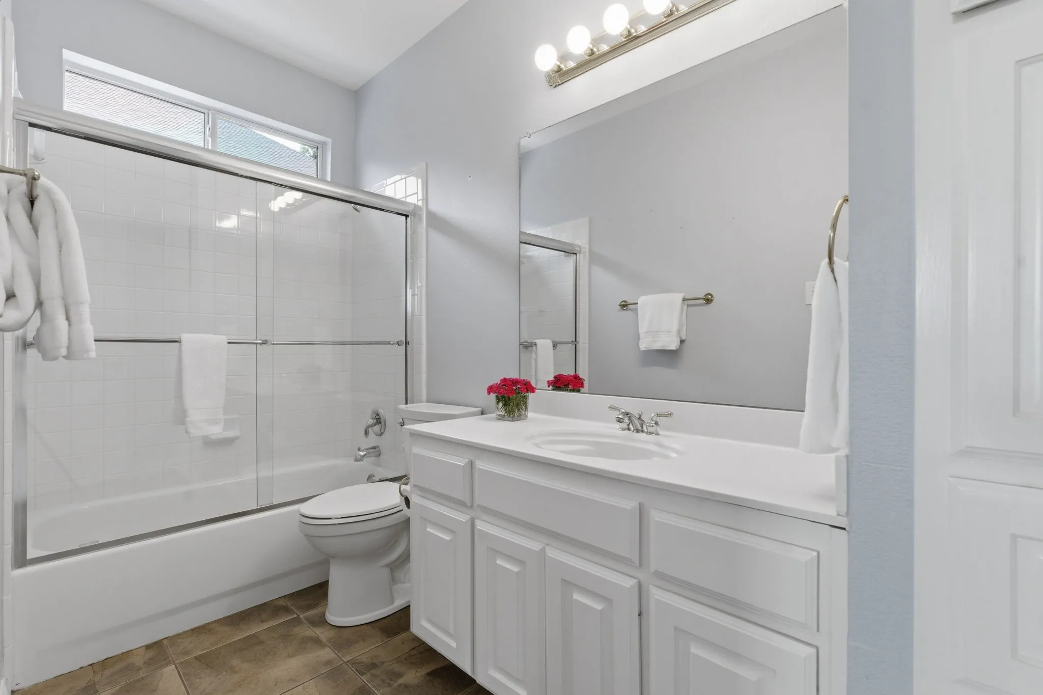 Downstairs full bath adjacent guest bedroom.