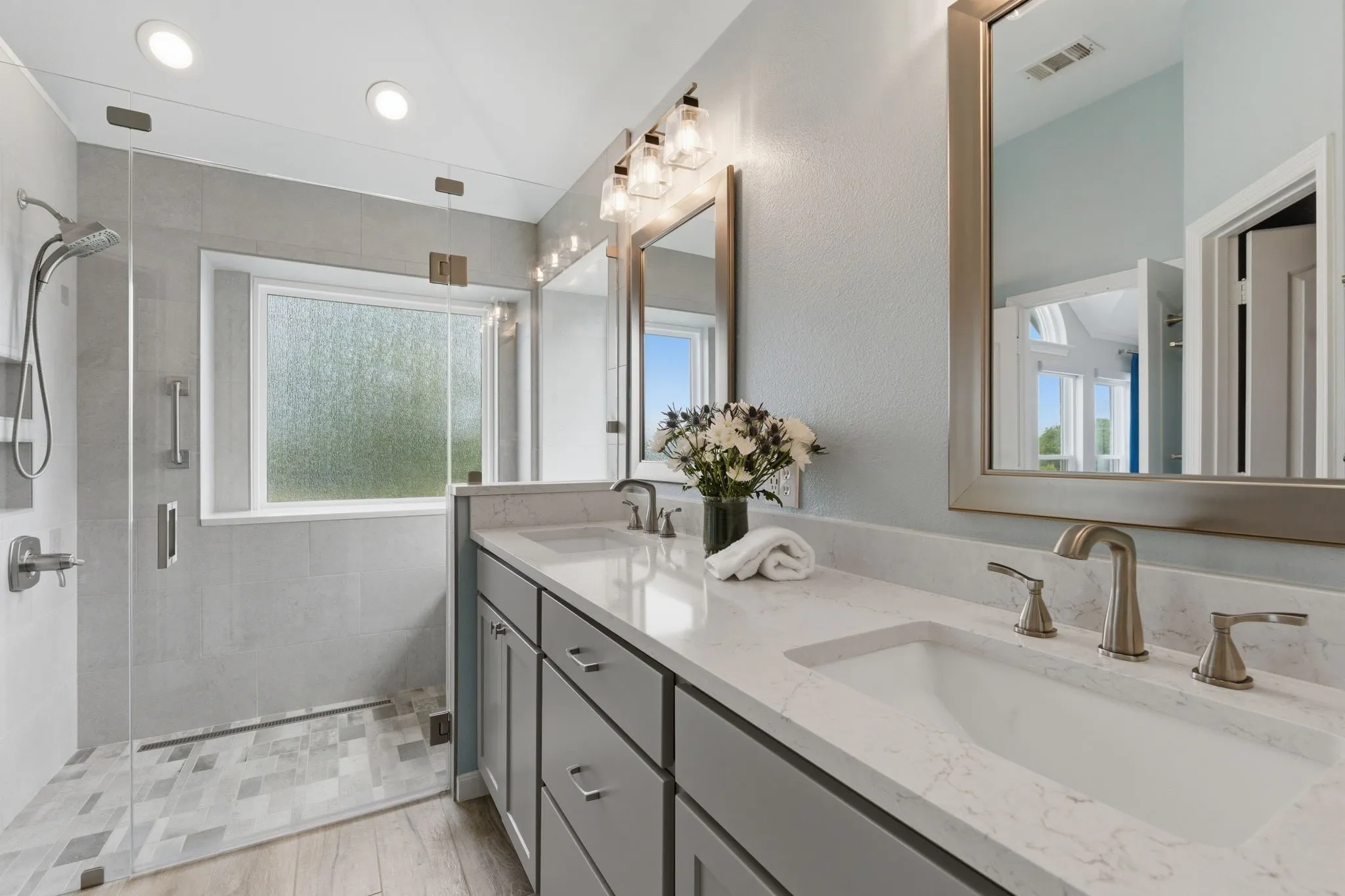 Beautifully updated fixtures and double sinks and spacious vanity.