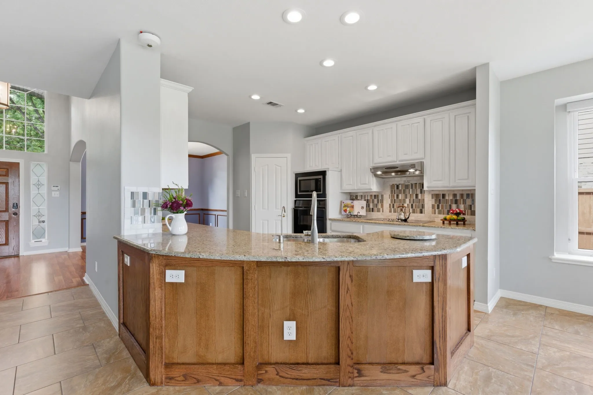 Updates include modern granite and backsplash, painted cabinets, fridge conveys.
