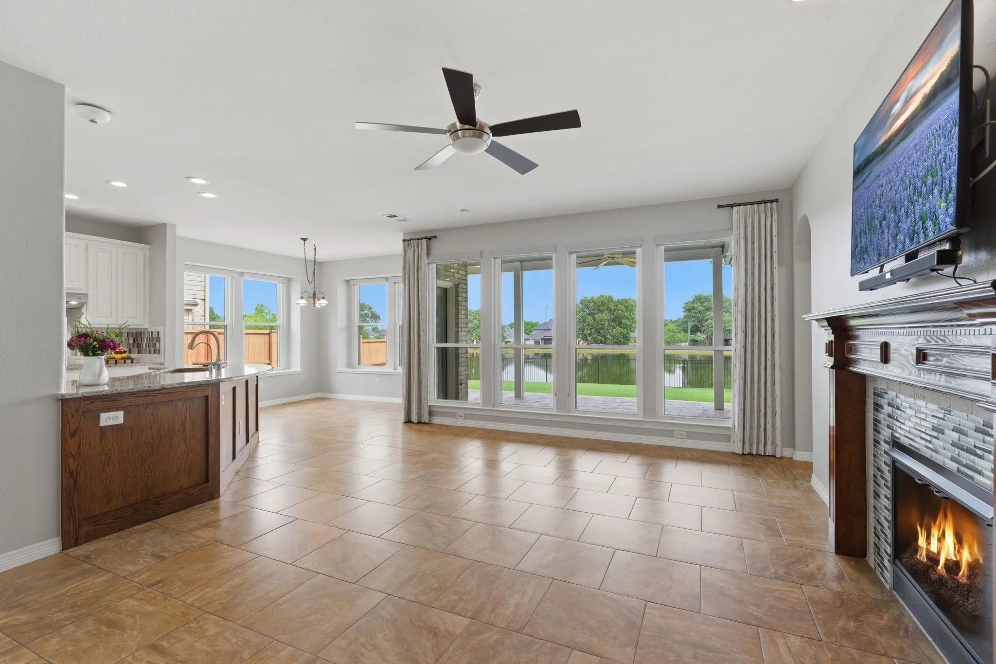 Clear views of the yard and lake along the wall of windows in the family room and breakfast room.