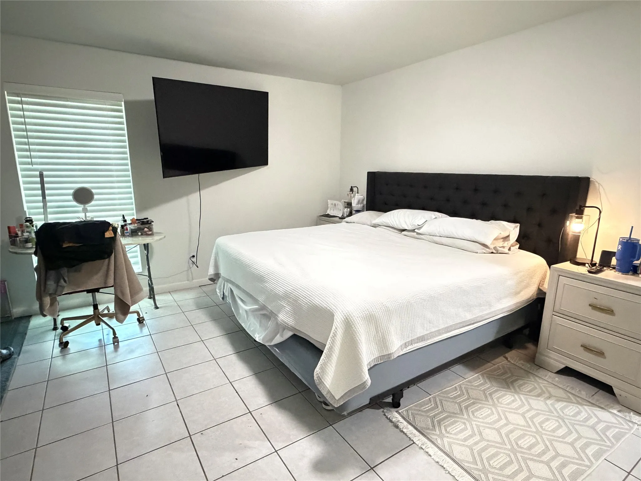 Bright interior space featuring light-toned walls and tile flooring