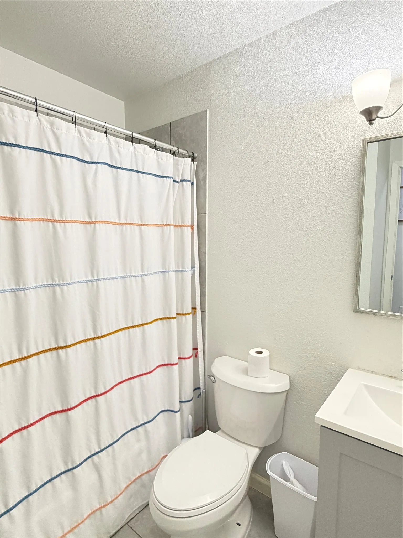 White ceramic toilet with a concealed trapway and a chrome flush lever