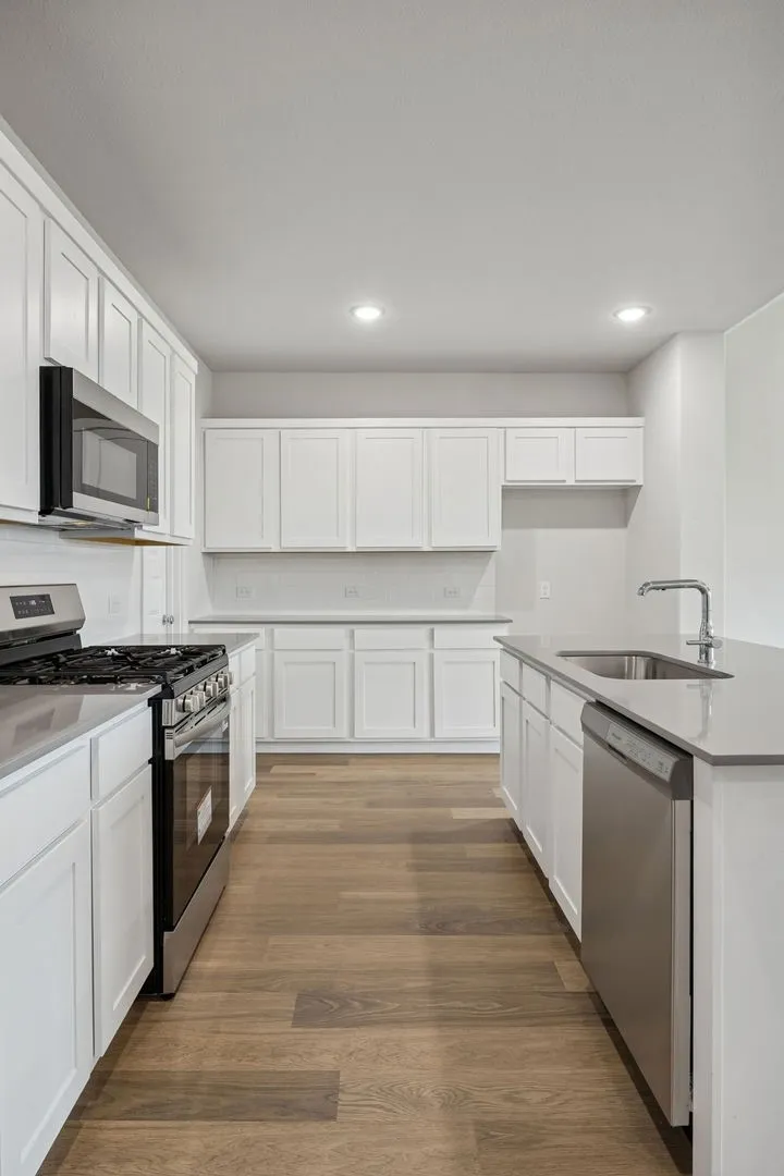 Kitchen in the Masters home plan by Trophy Signature Homes – REPRESENTATIVE PHOTO