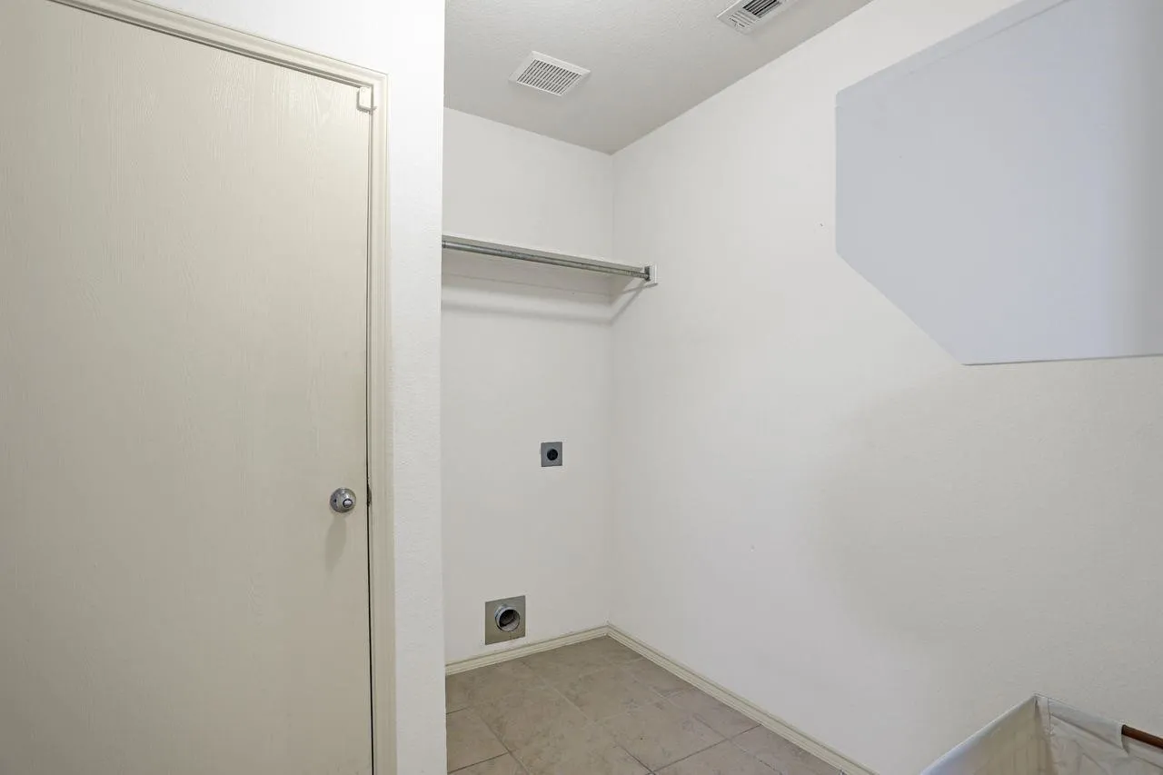 Dedicated laundry area featuring a hanging rod, appliance hookups, and tiled flooring