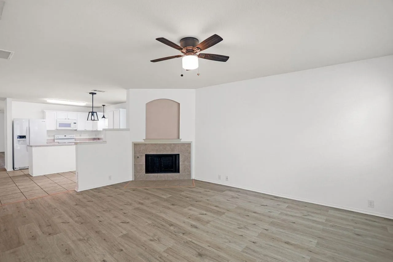 Open-concept living space featuring wood-finish flooring and a ceiling fan