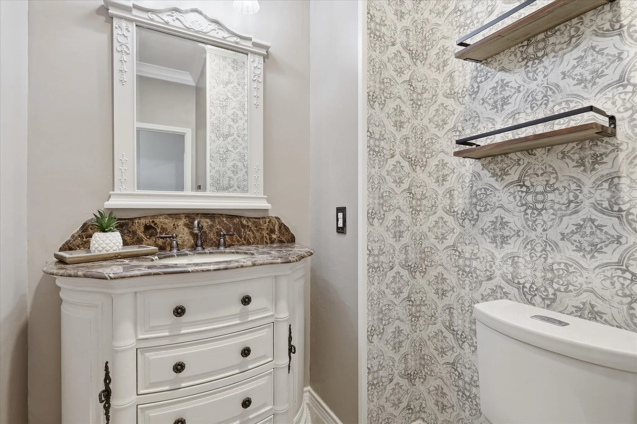 Powder bath tucked in by downstairs family room