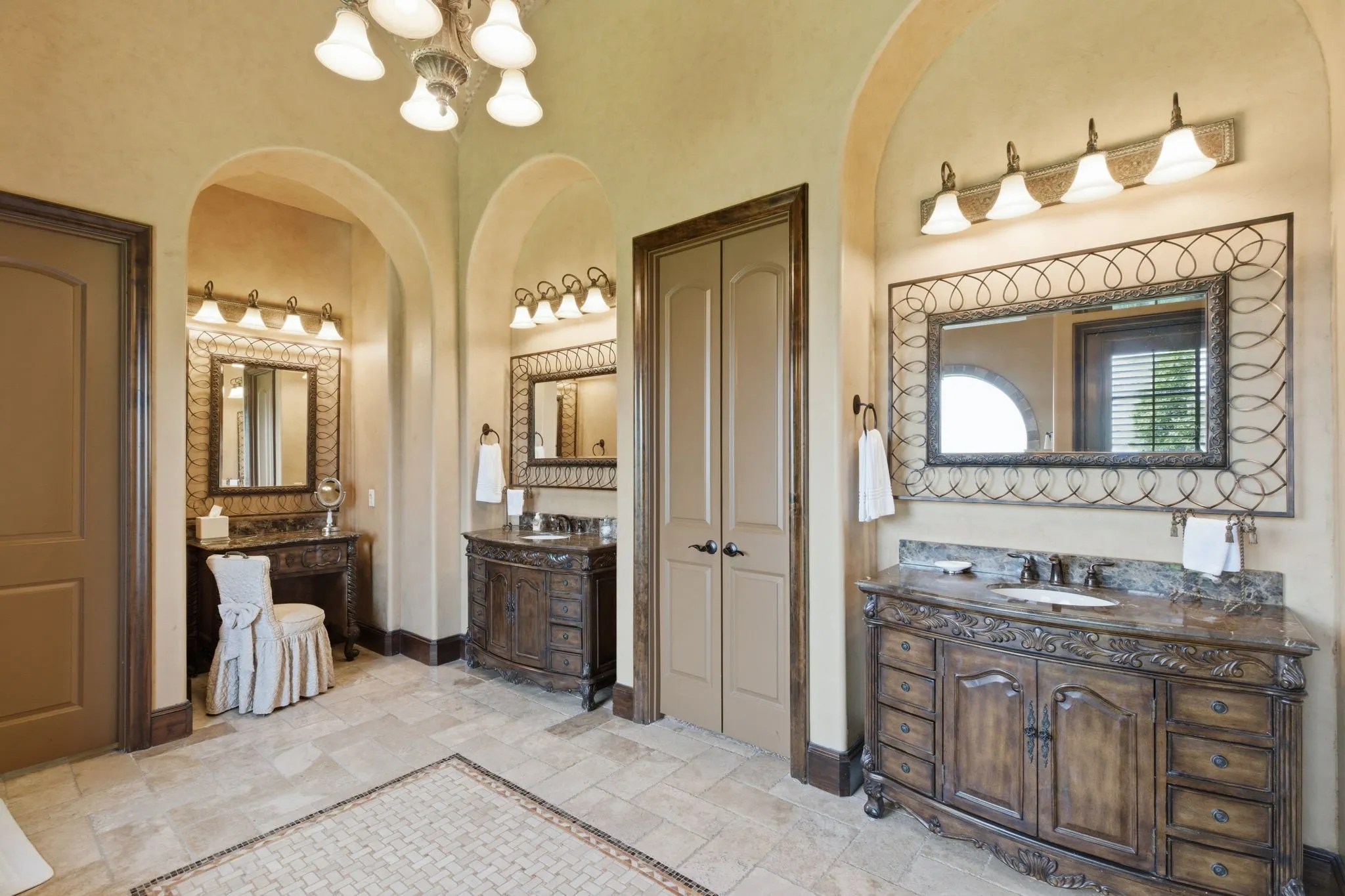 Spacious bathroom featuring stone tile flooring with decorative inlay