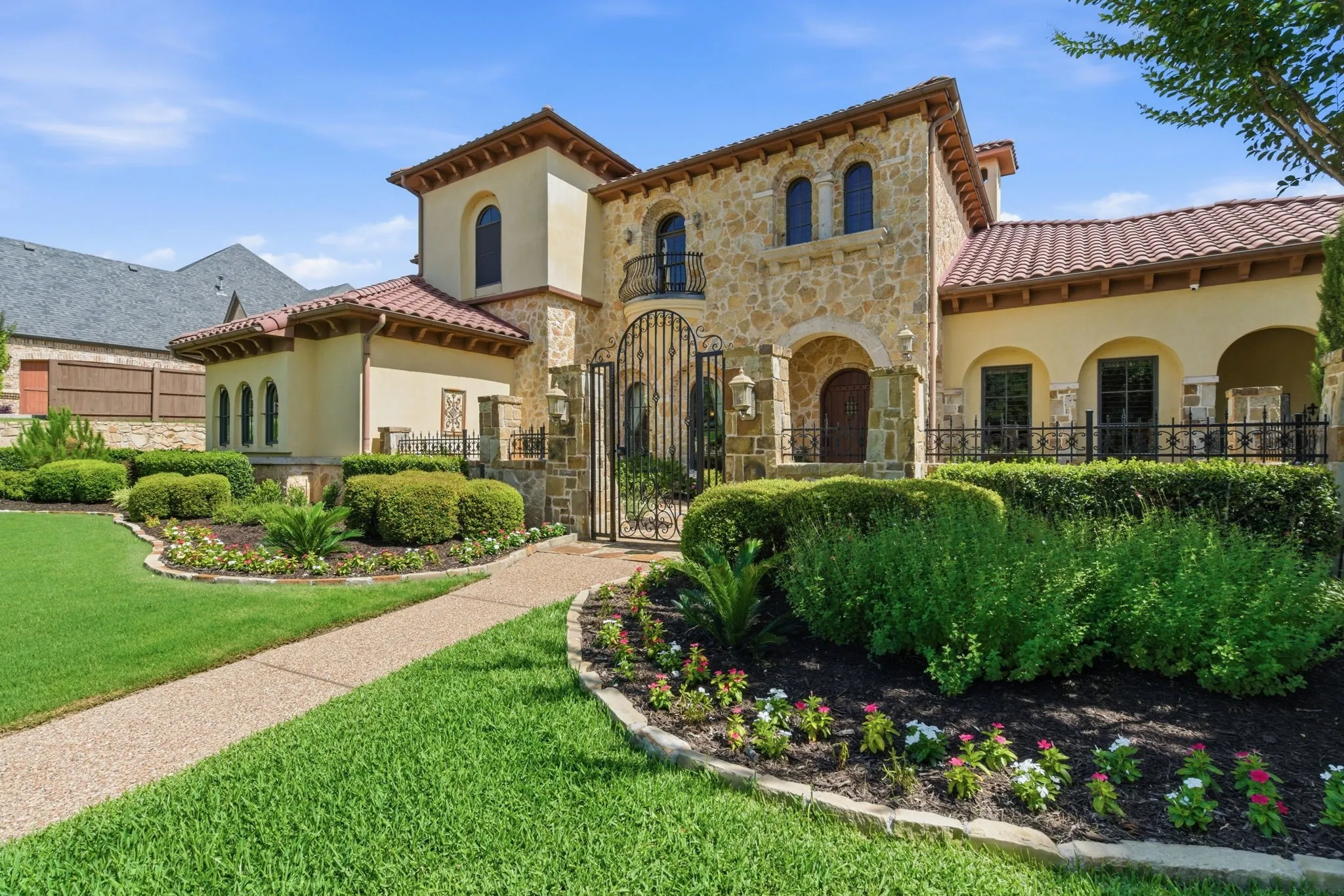 Mediterranean-inspired exterior with stone facade and stucco accents