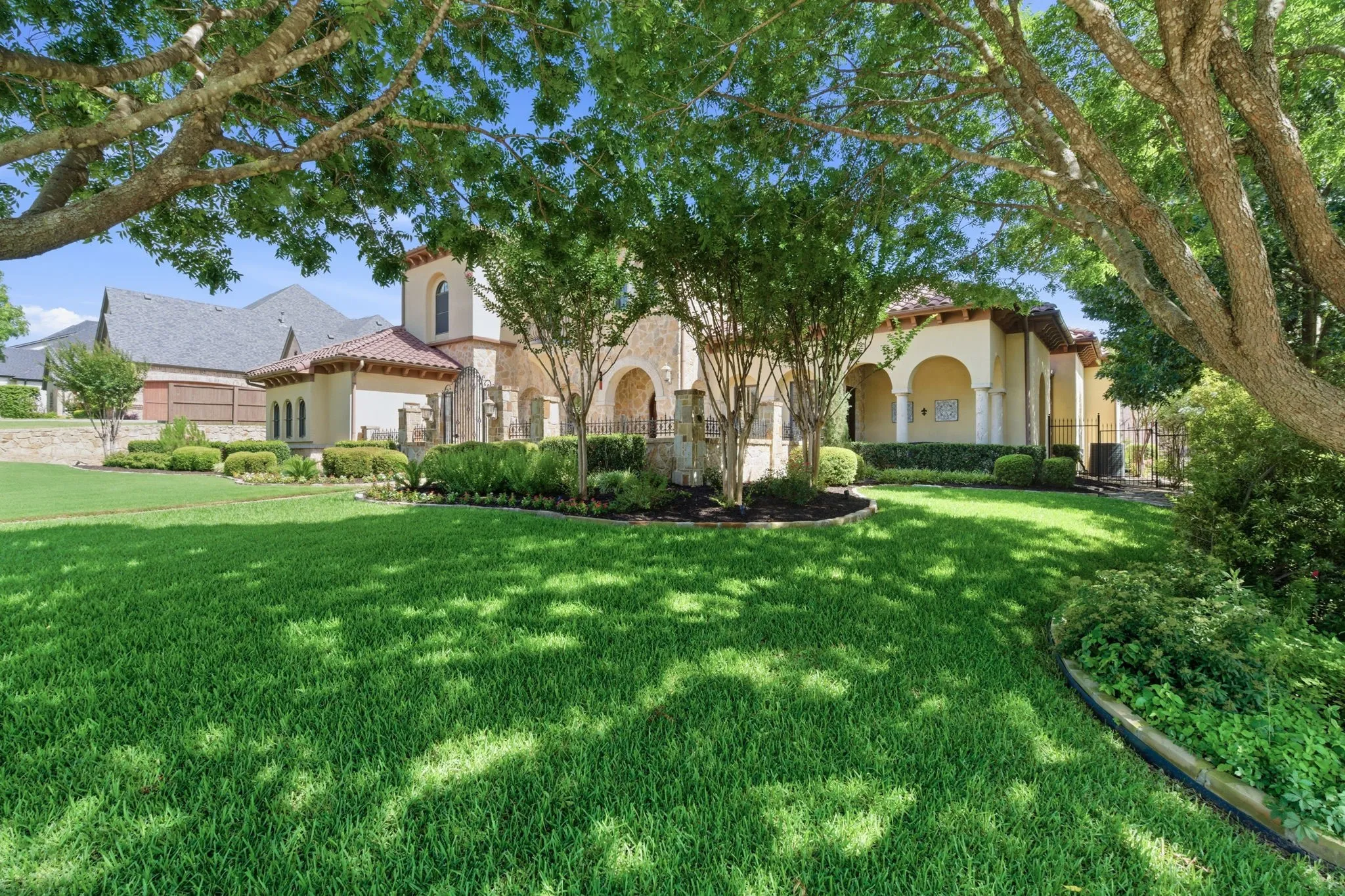 Spacious front lawn with mature trees providing shade