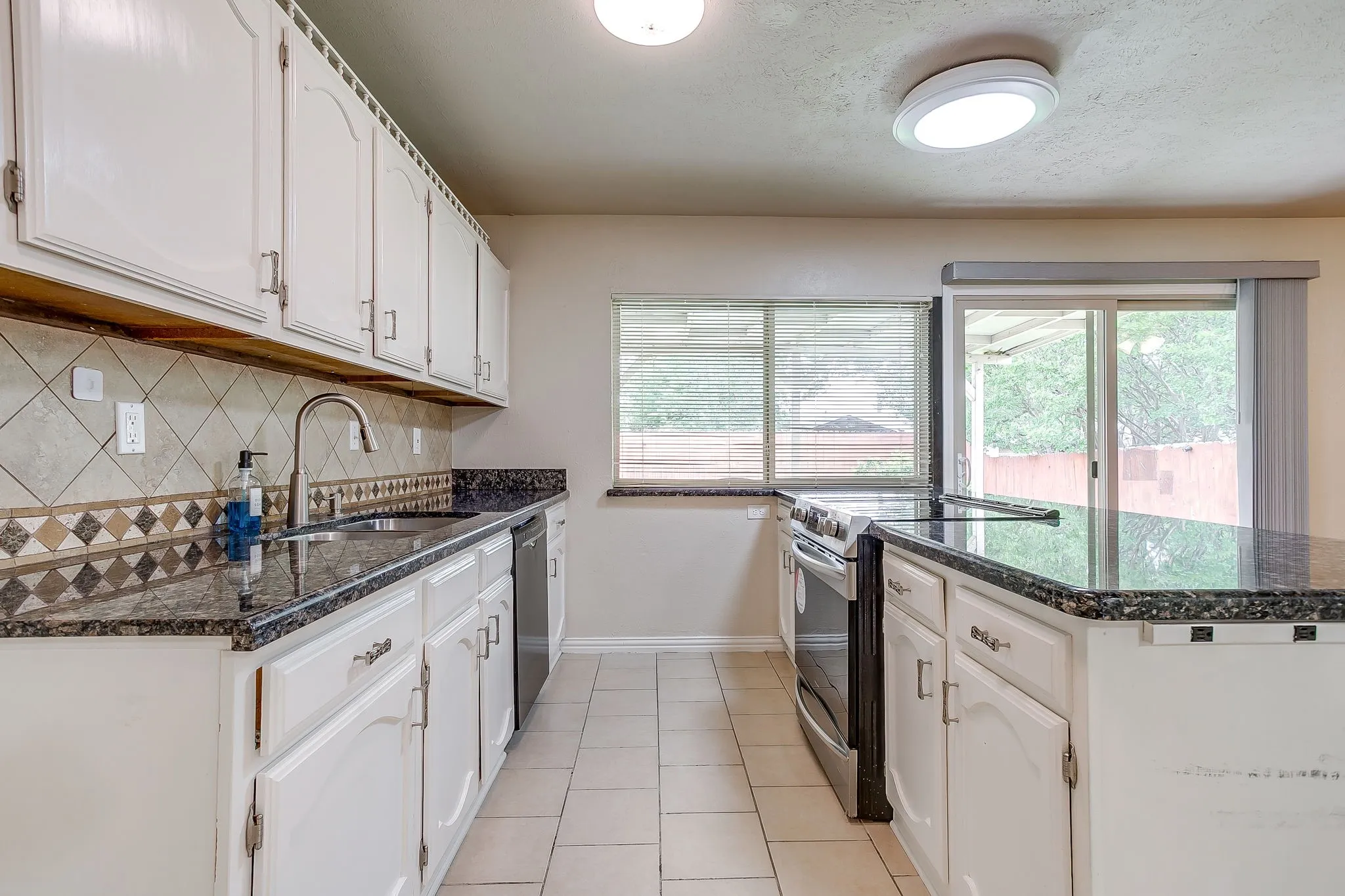 The spacious kitchen features SS appliances and plenty of counter & cabinet space