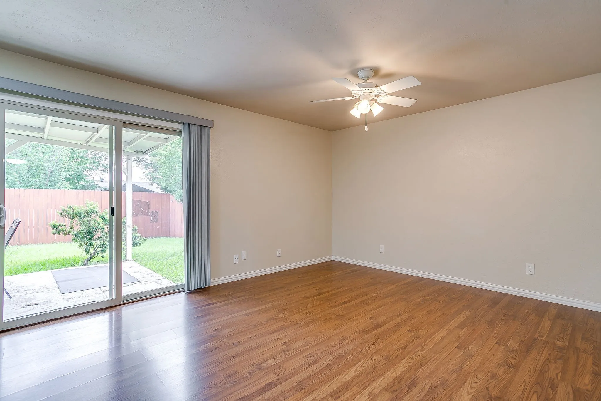 The spacious family room opens to the nice backyard and patio