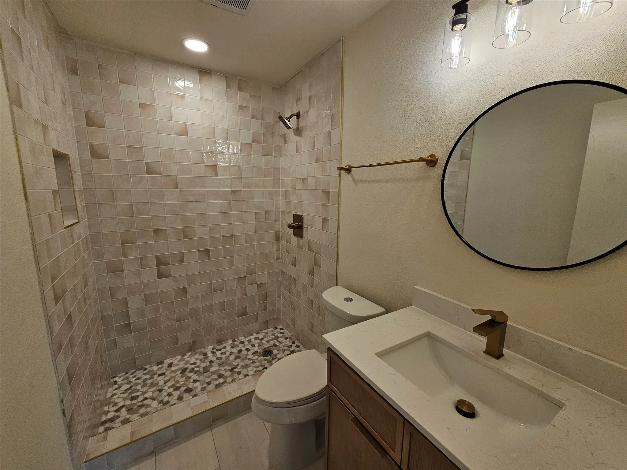Contemporary bathroom featuring a walk-in shower with mosaic wall tile and pebble floor