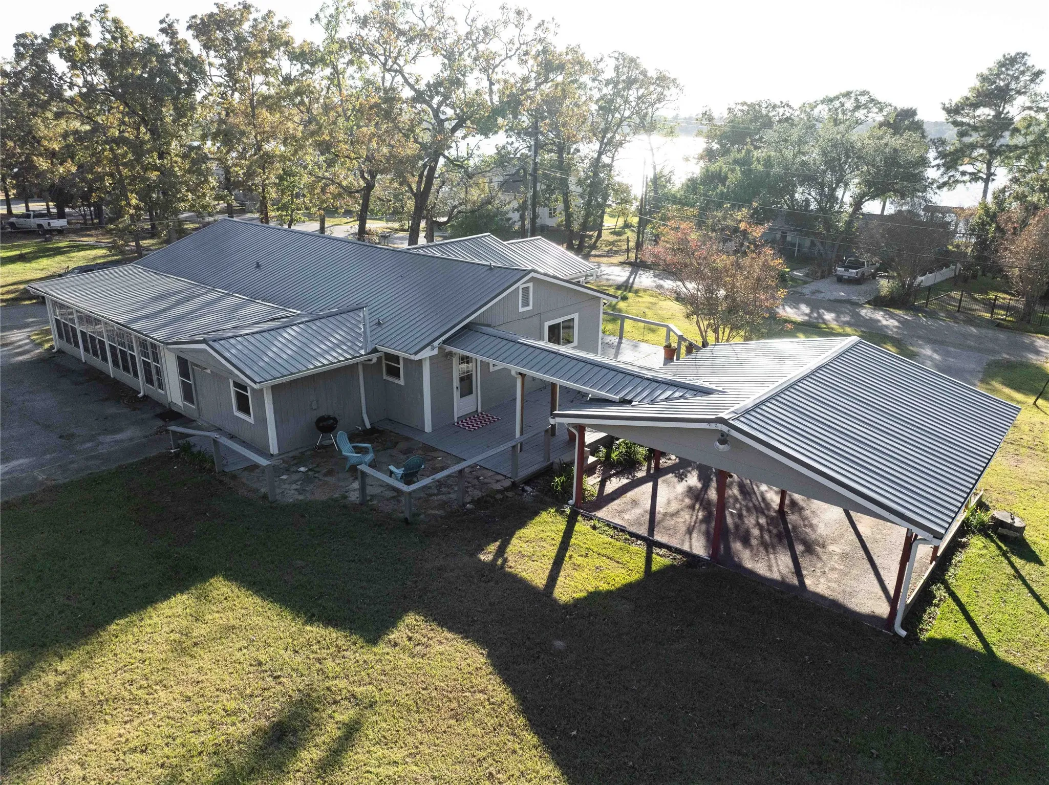 view of side and back of home with carport with water view