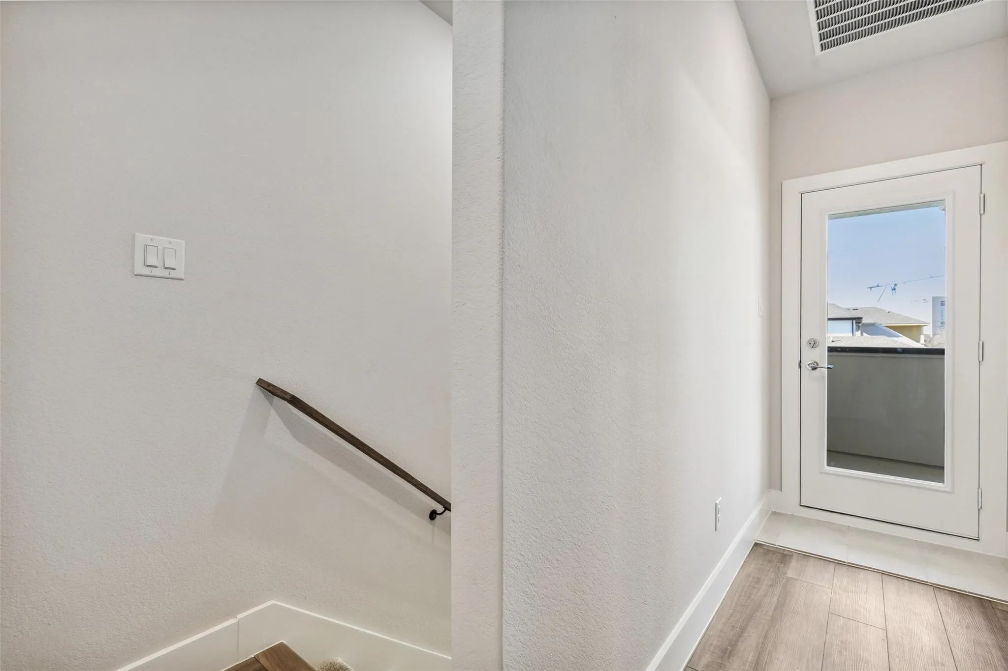 SECOND STAIRWELL TO PRIMARY SUITE WITH ENTRANCE TO PATIO AREA ON THIRD LEVEL