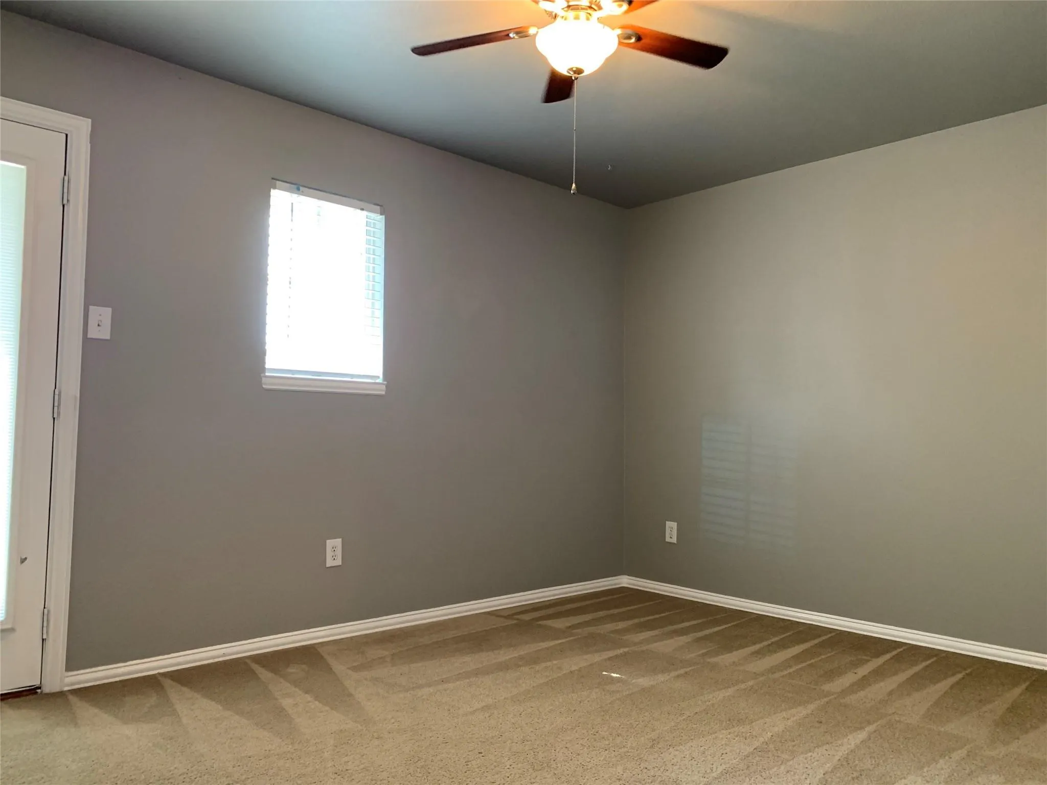 Neutral-toned walls complement the light brown carpet