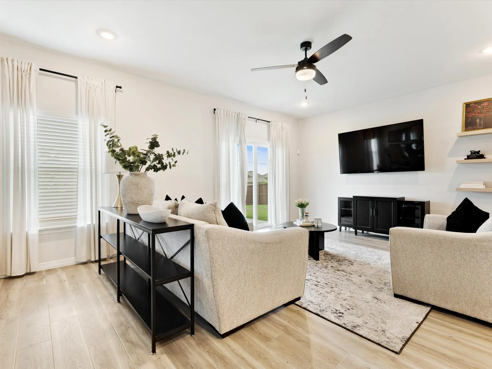 Living area featuring light wood-finish flooring, recessed lighting, and a ceiling fan