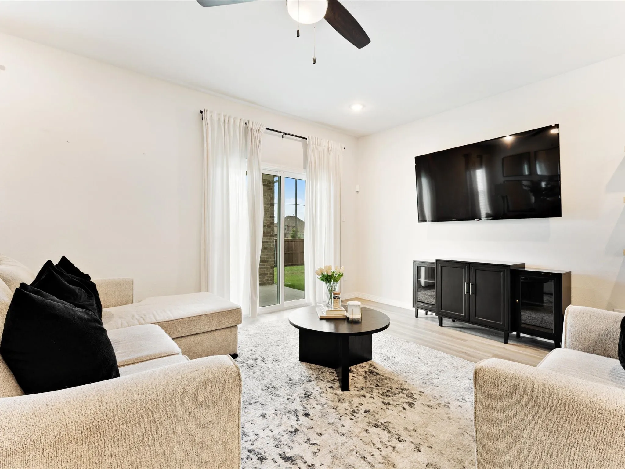 Living area featuring light wood-finish flooring, recessed lighting, and a ceiling fan