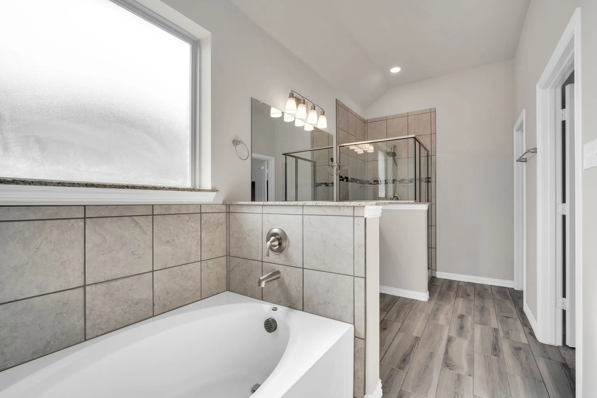 Dual vanity with light gray cabinetry, granite countertop, and undermount sinks