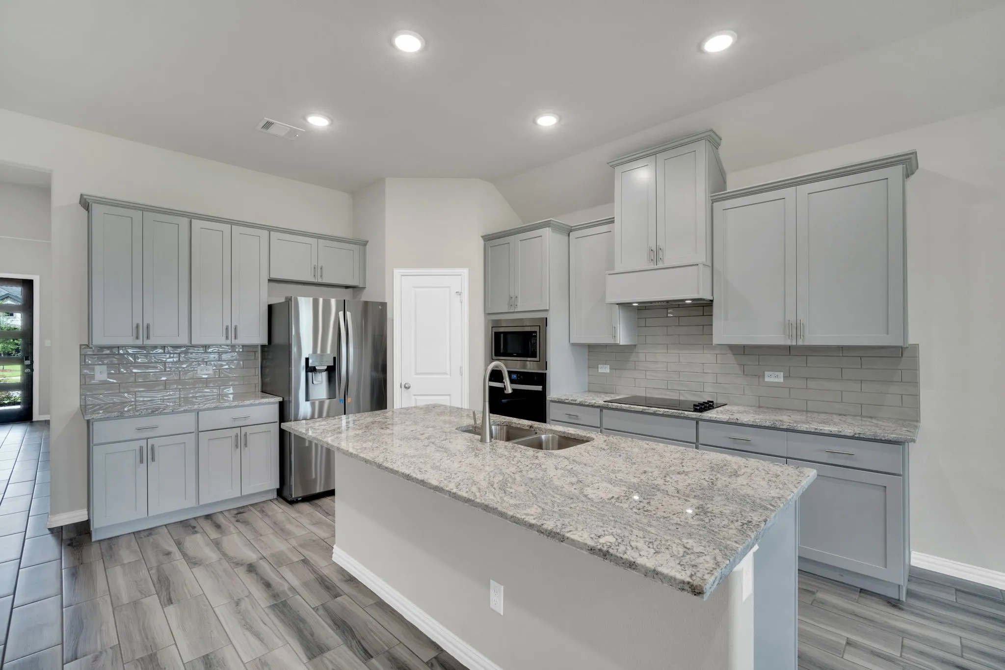 Modern kitchen featuring an expansive center island with an undermount double sink