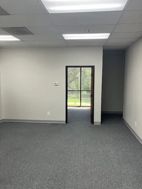 Interior space with gray carpet flooring and light-toned walls