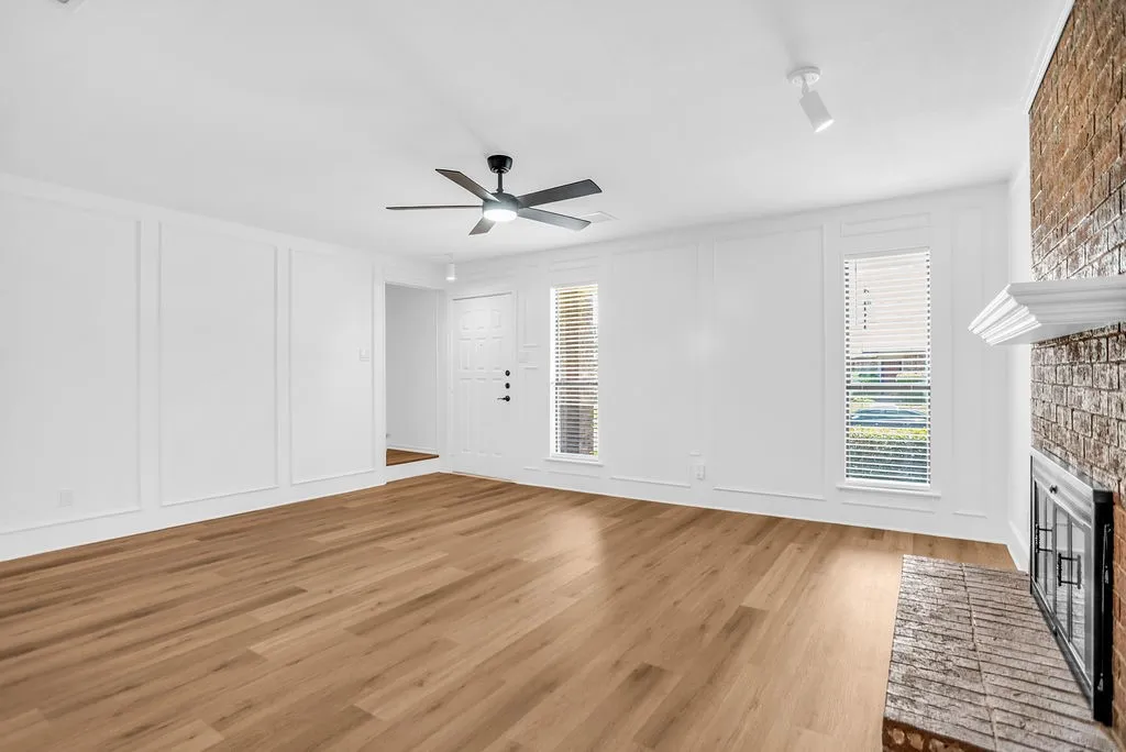 Living room with stairwell entrance on left.