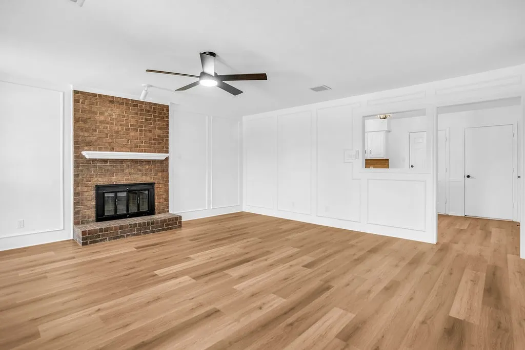 Open and inviting living room centered with a wood burning fireplace.