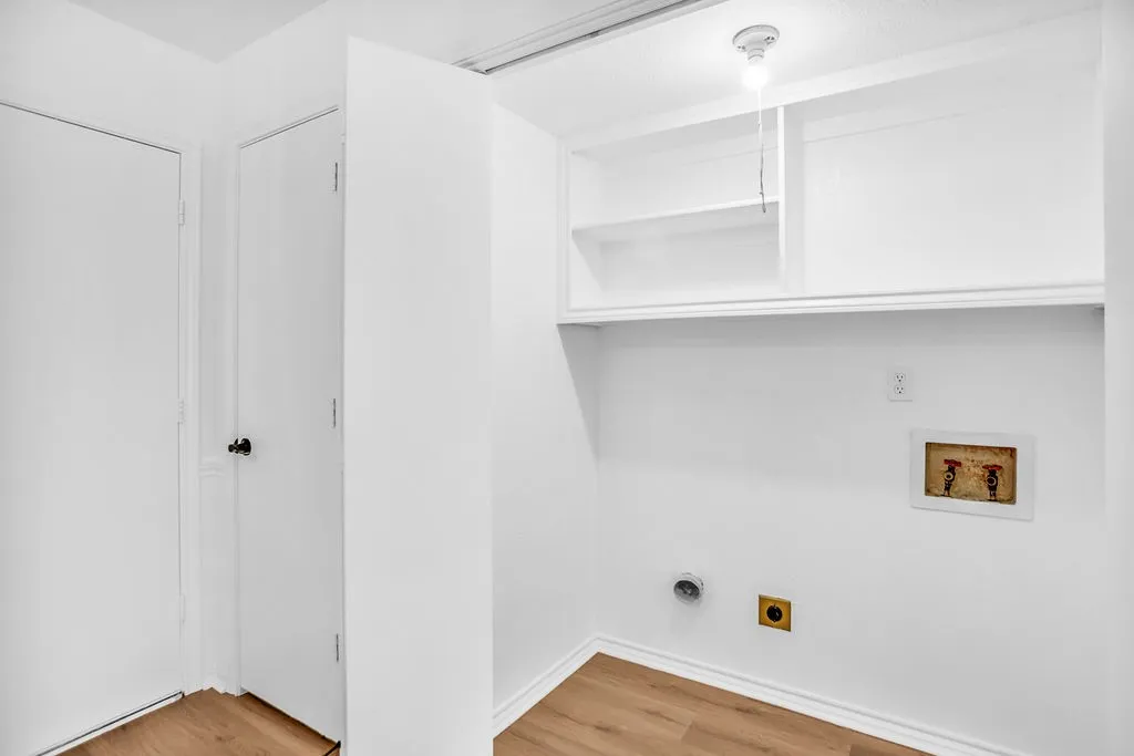 Full size utility area with shelving.