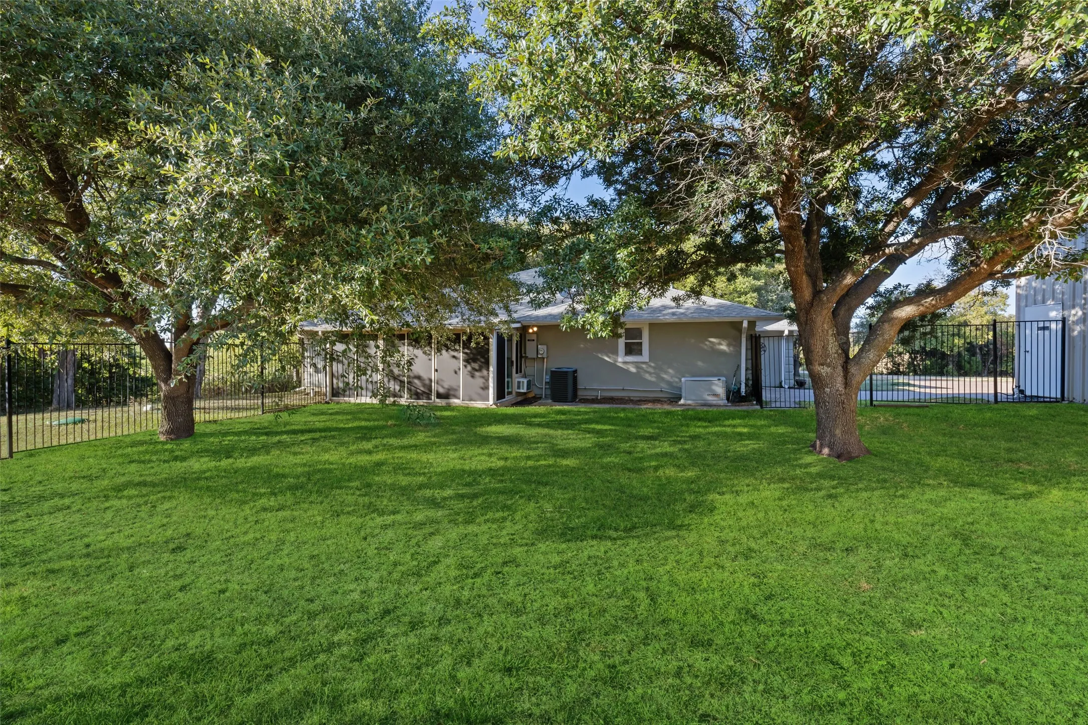 Fenced backyard and sunroom. Generac generator.