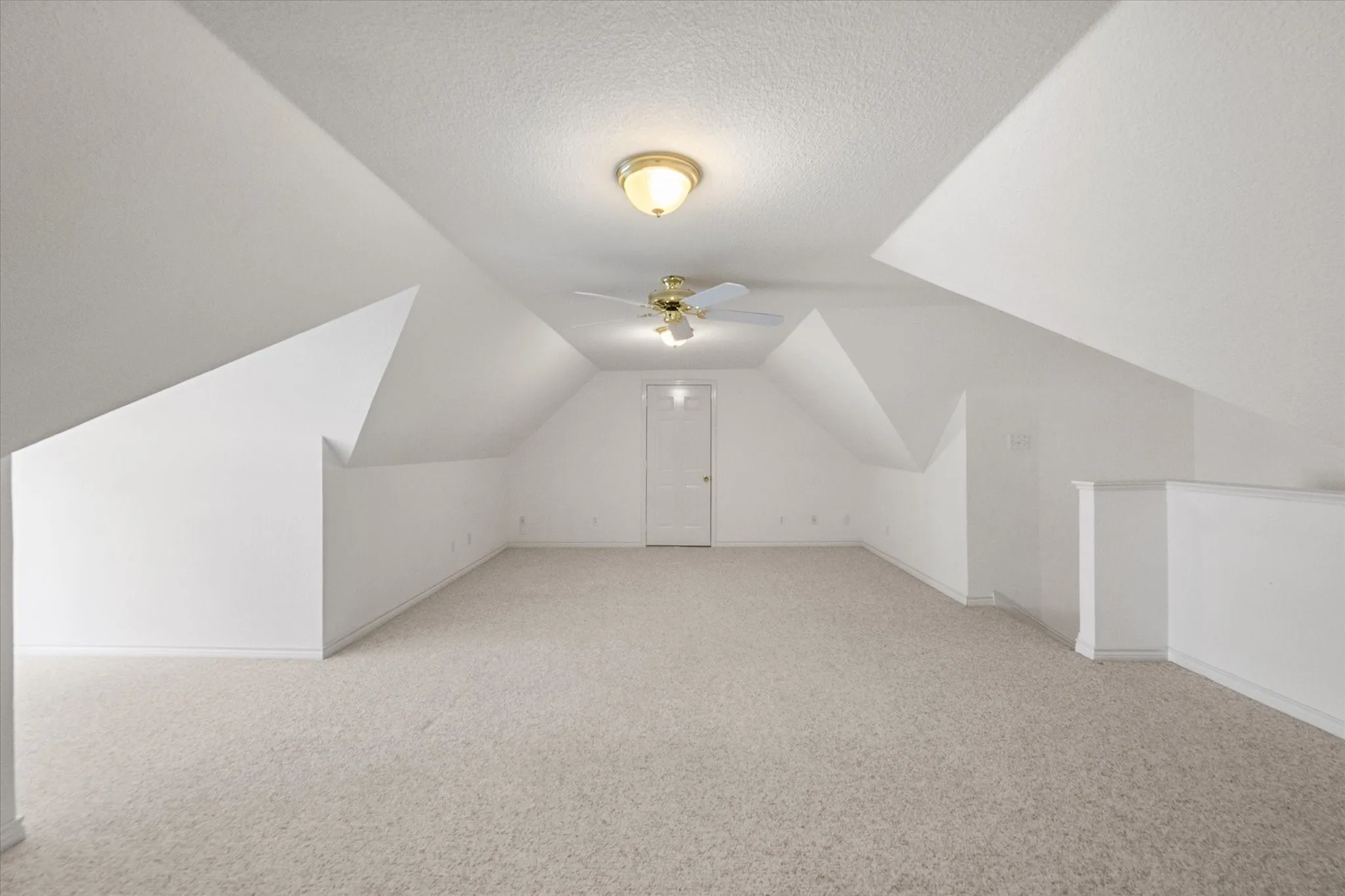 Large bonus room near Corsicana with angled ceilings, open floor space, and great potential for a hobby or media room.